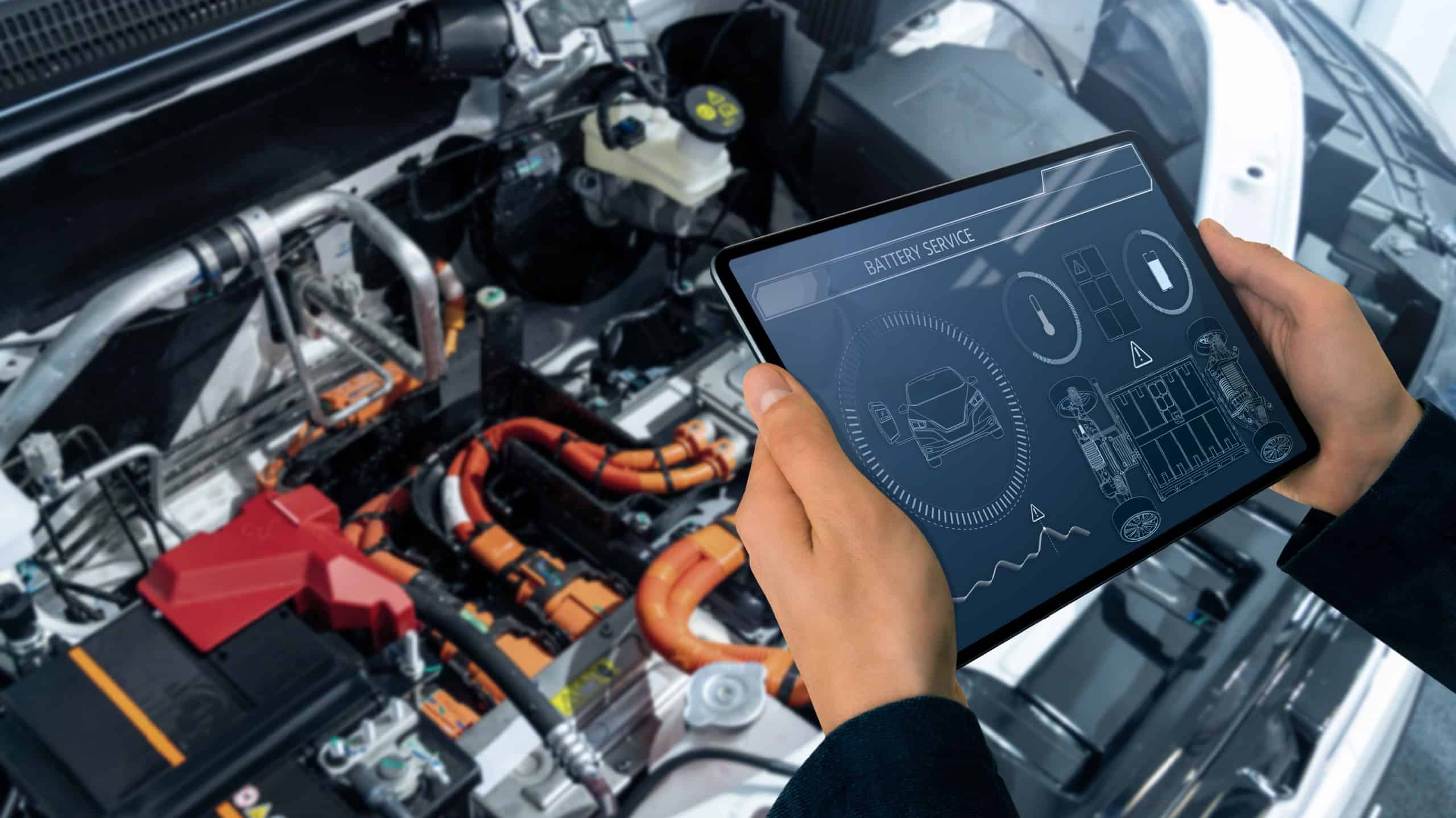 Checking the battery pack of an electric car at a service center.