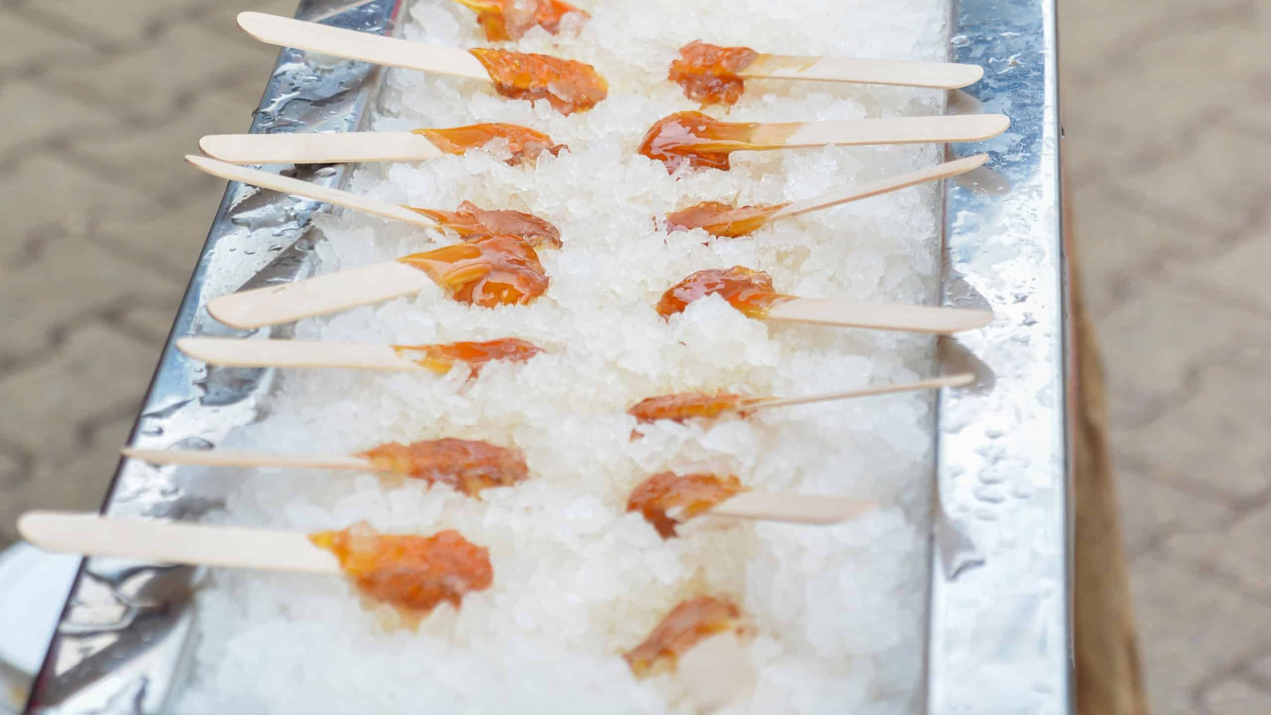 Hot maple syrup on a stick in the snow