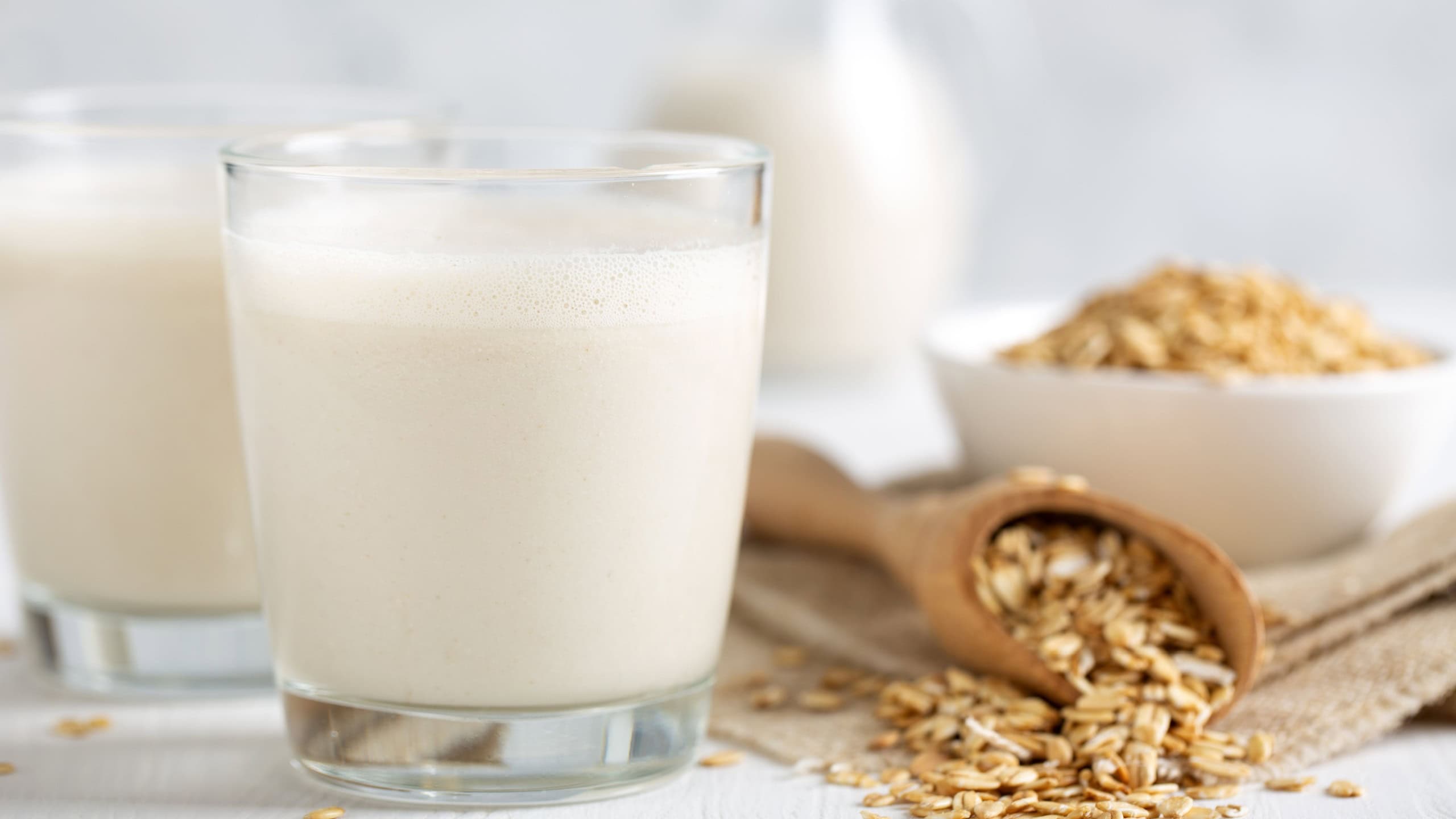 Oat milk. Healthy vegan non-dairy organic drink with flakes