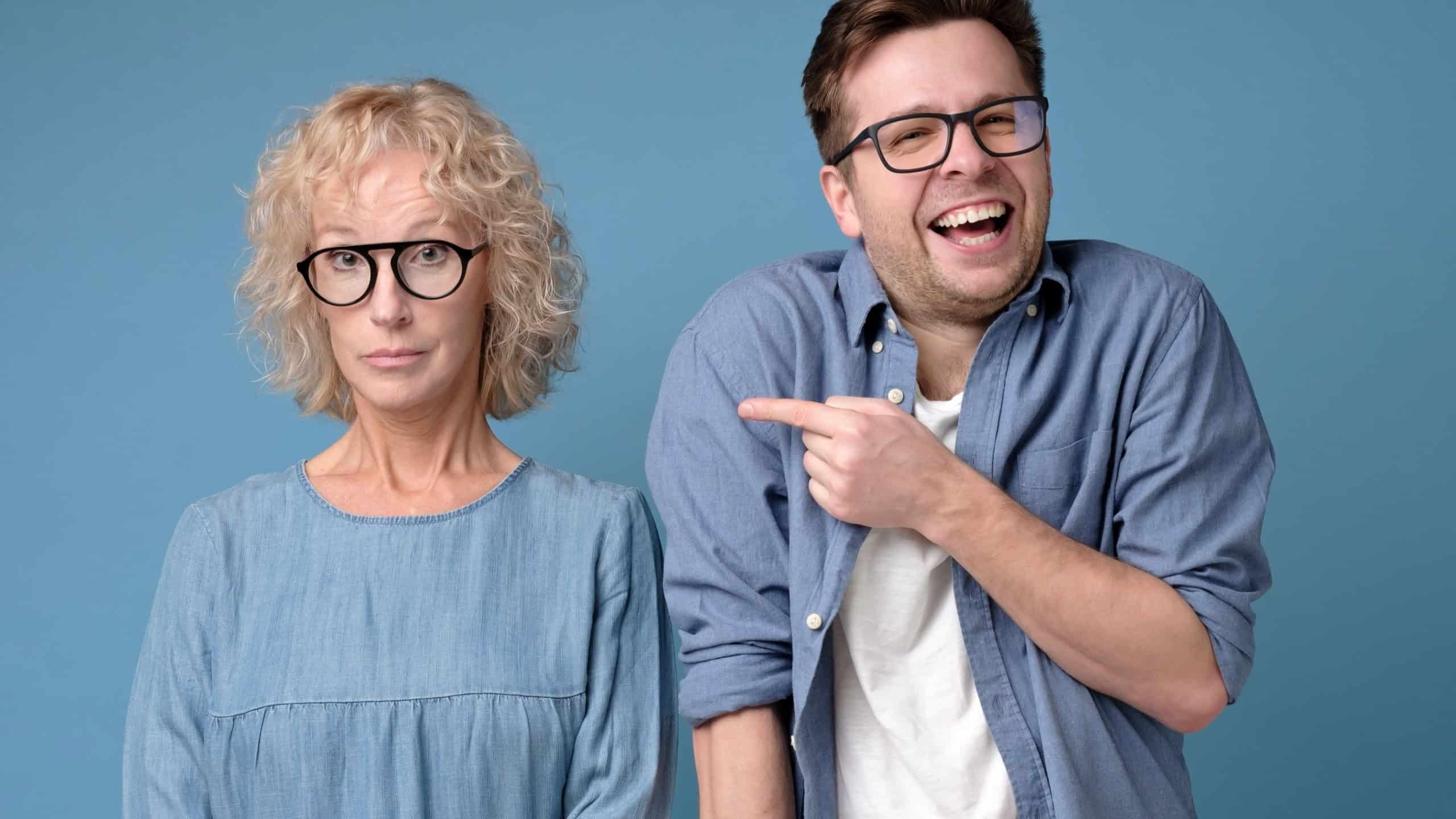 Cheerful handsome man laughing at woman
