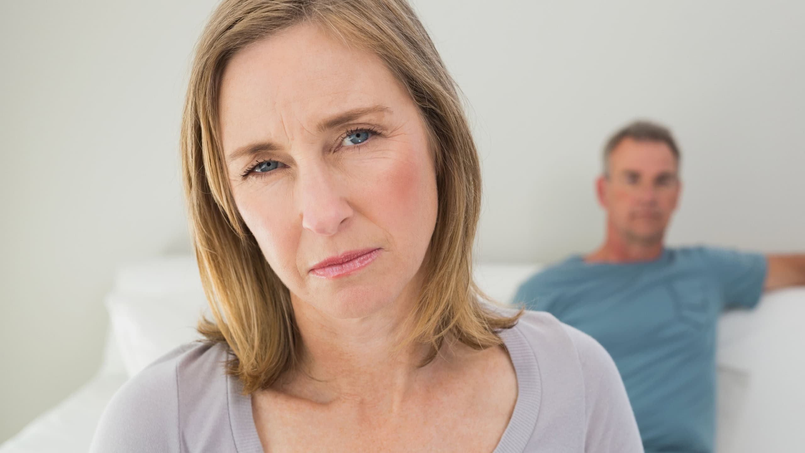 Unhappy couple not talking after an argument in the living room at home