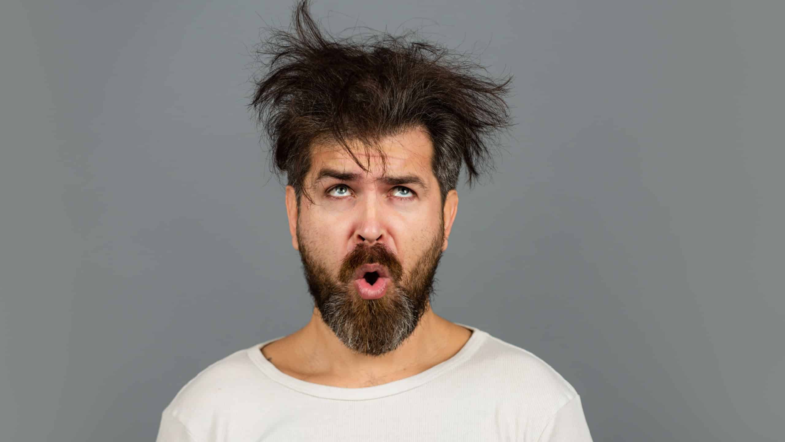 Funny and crazy. Bearded man with messy hair. Barbershop concept. Long beard and moustache