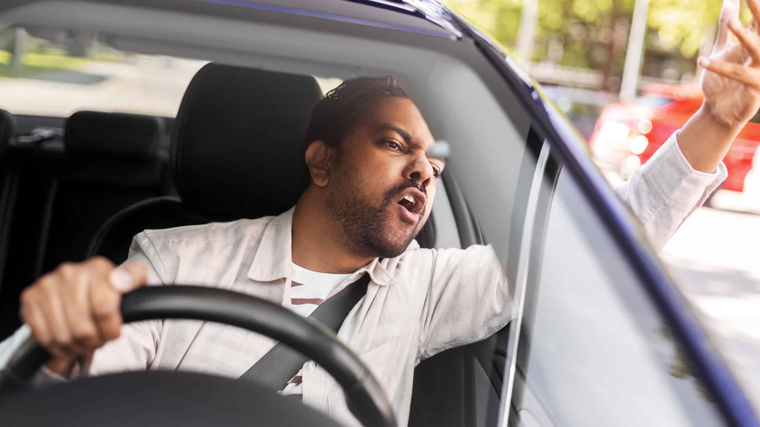 transport, vehicle and people concept - angry indian man or driver driving car and gesturing