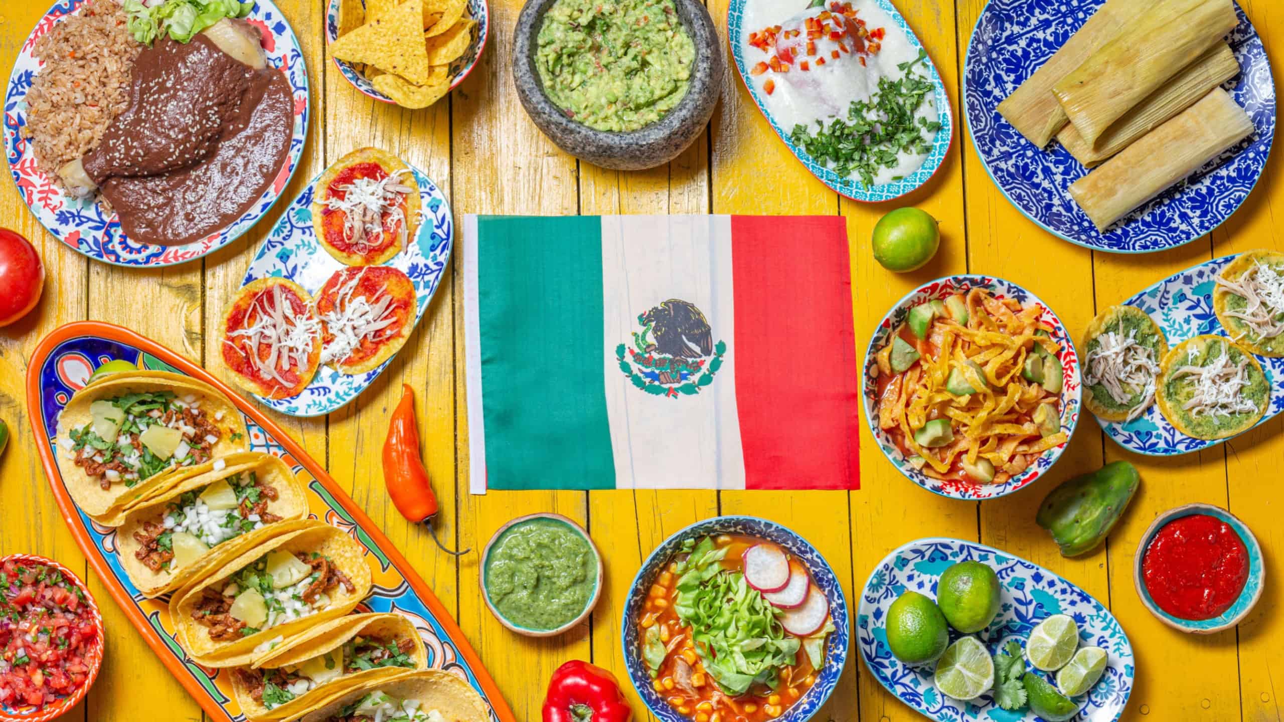 Mexican festive food for independence day independencia - around mexican flag. Top view , Yellow background