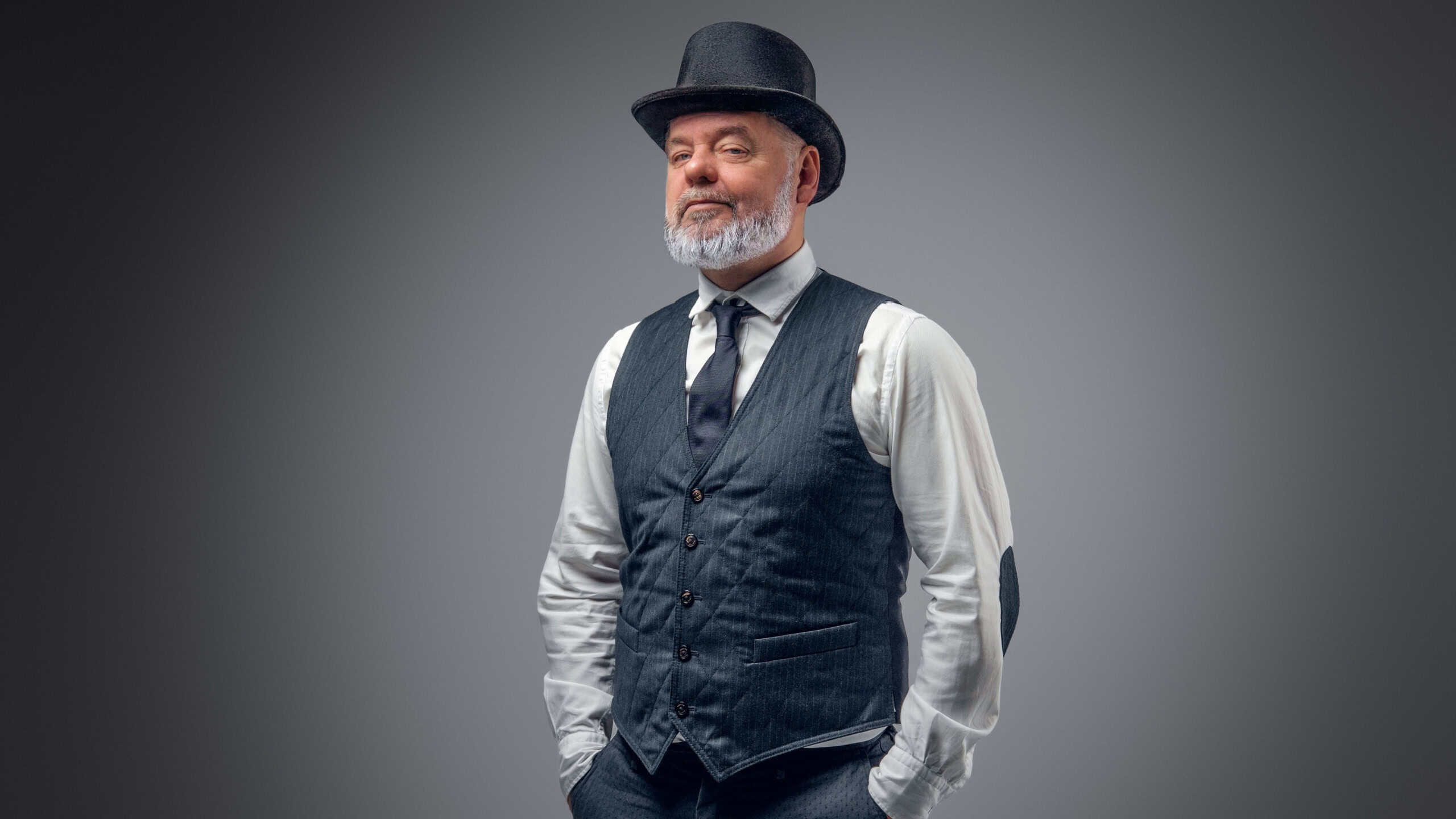 Shot of elderly man dressed in stylish old fashioned costume with top hat.