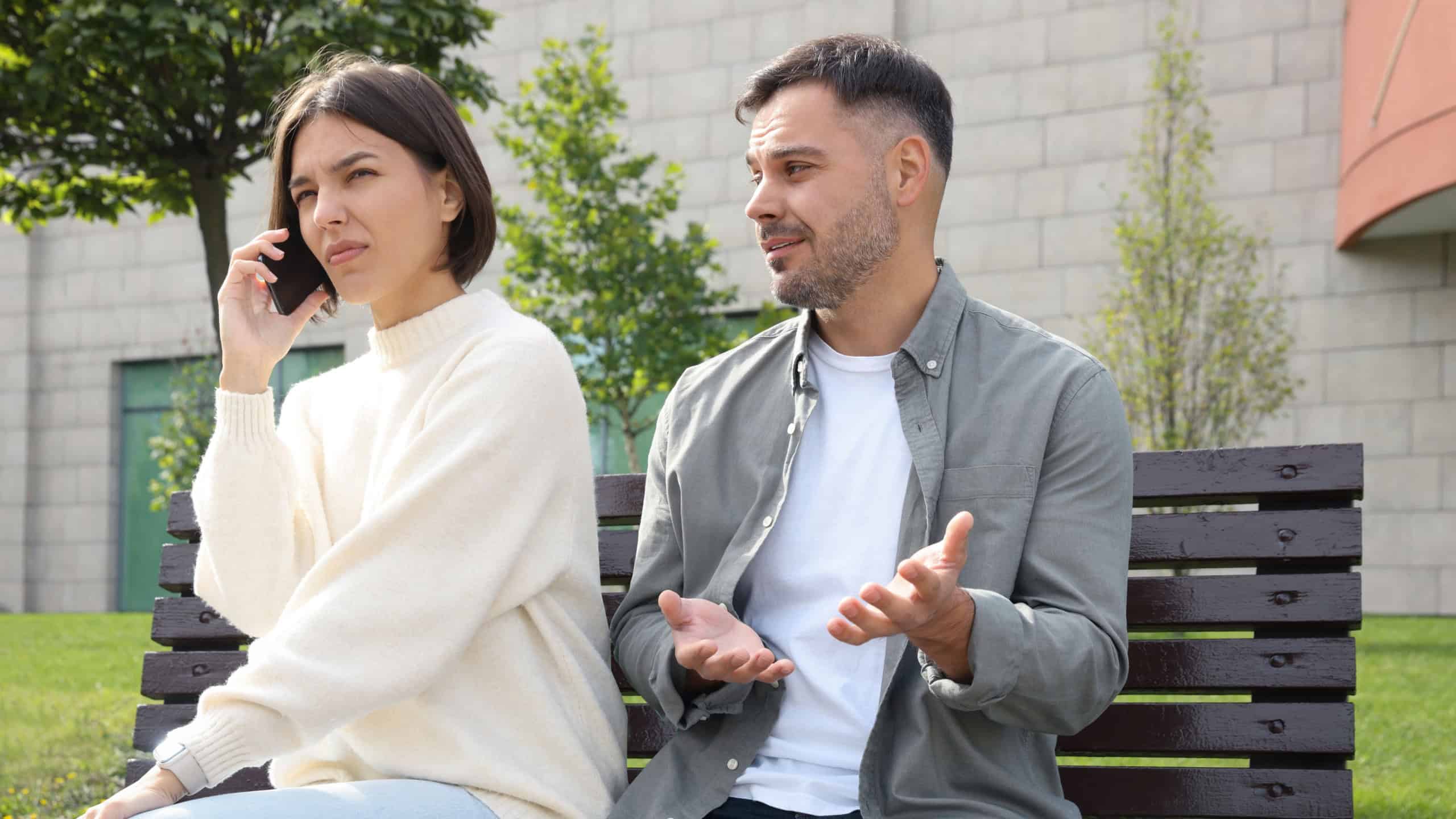 Woman ignoring her boyfriend and talking on phone. Relationship problems