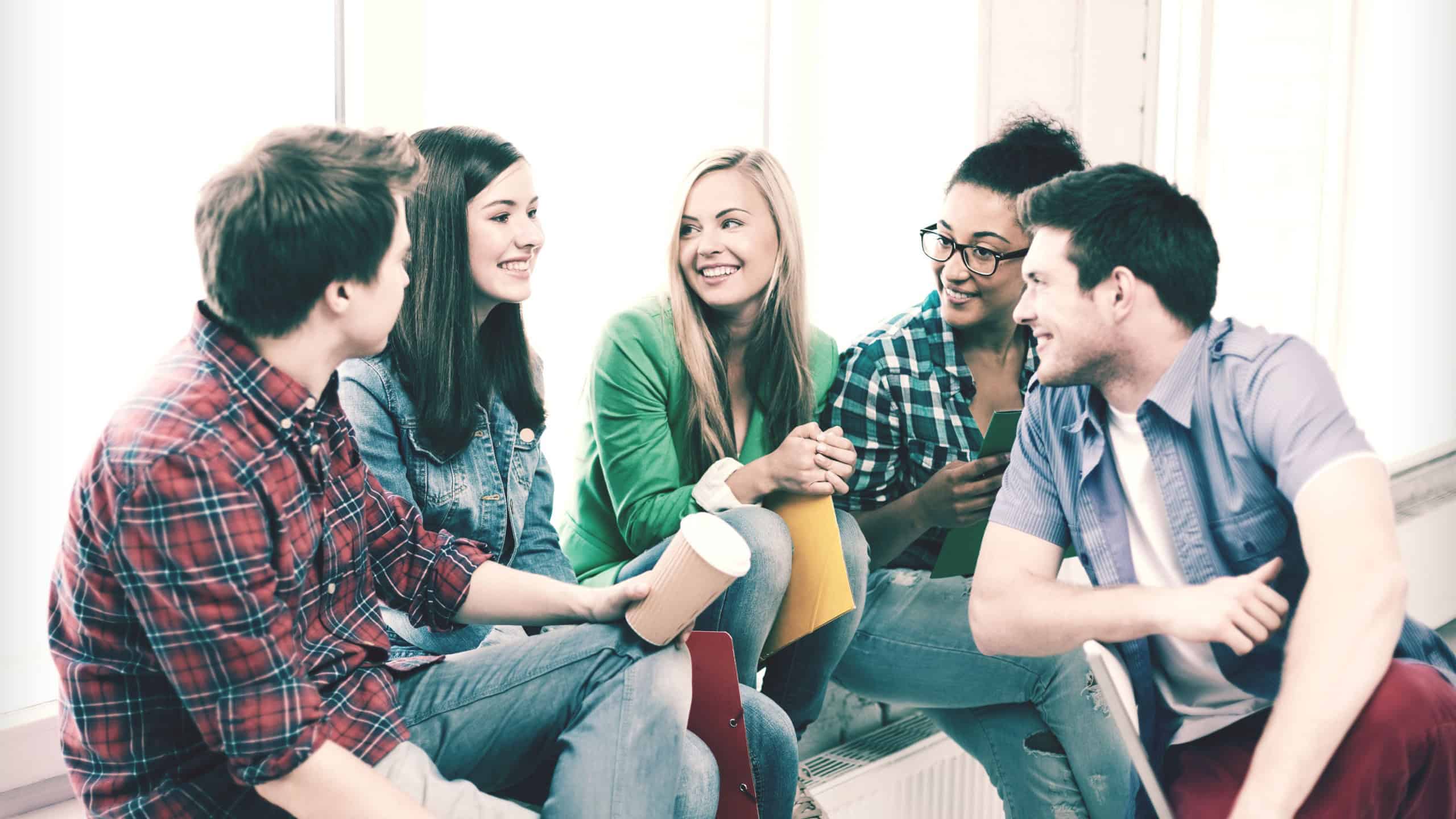 education concept - students communicating and laughing at school