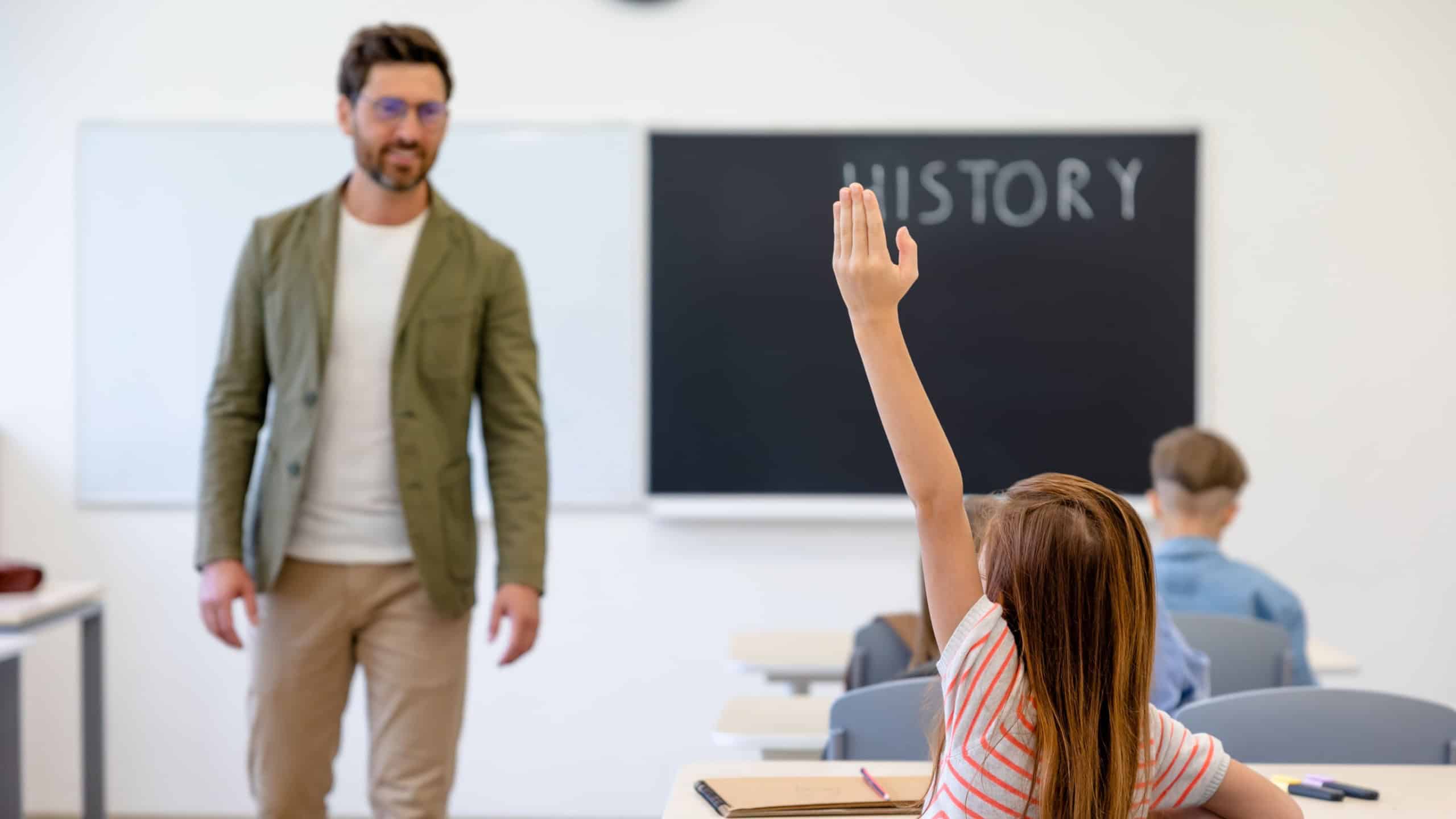 Male teacher and the kids at the history lesson