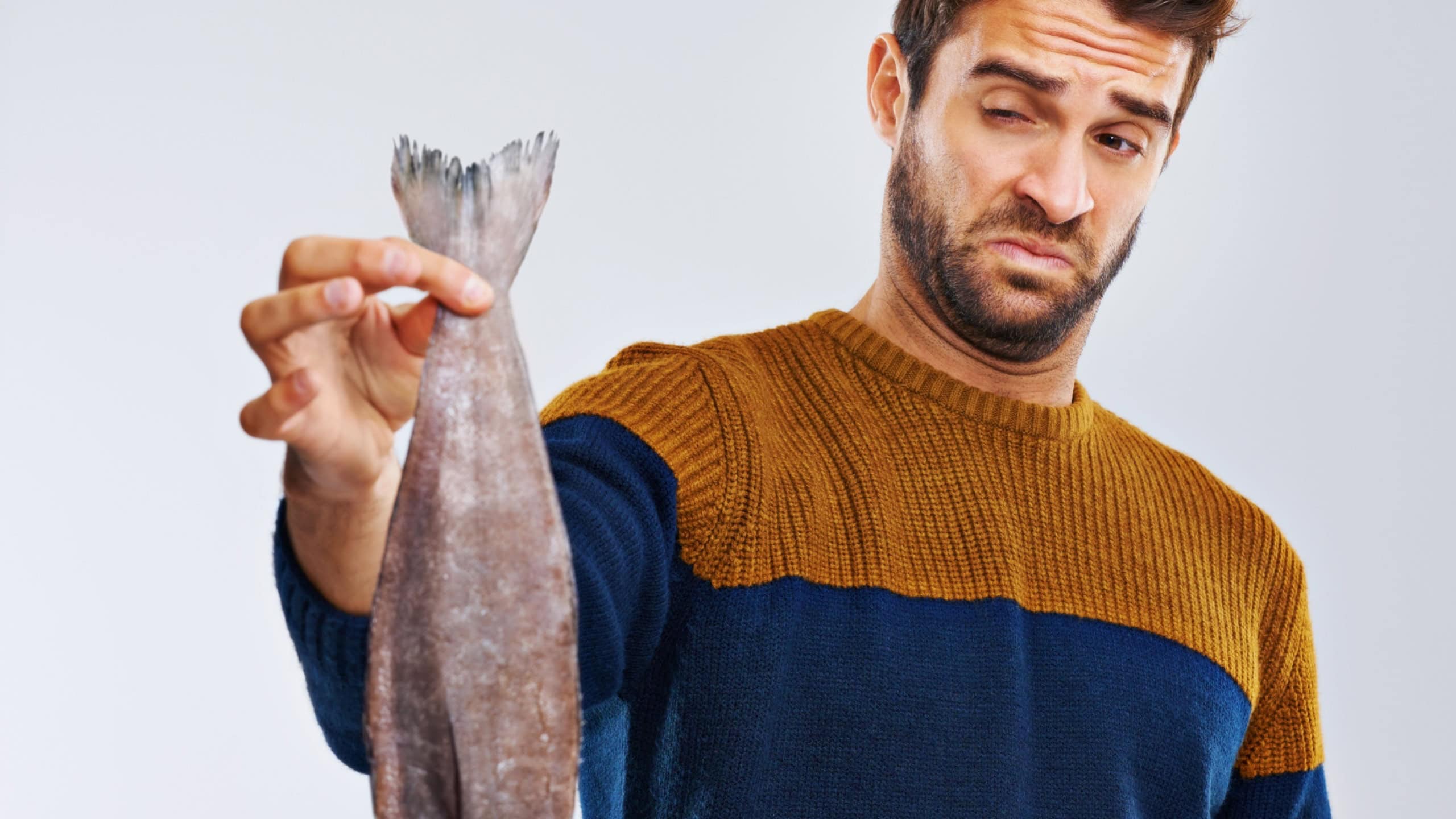 Man, disgust and fish with bad smell, odor or stink of animal or sea creature
