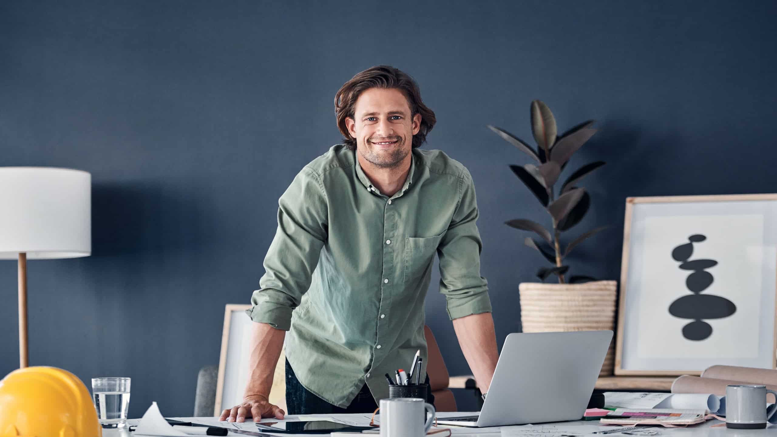 Businessman, architect and portrait with laptop in office for remodeling ideas and building design research. Engineering, employee and person with technology, happy and online for project management