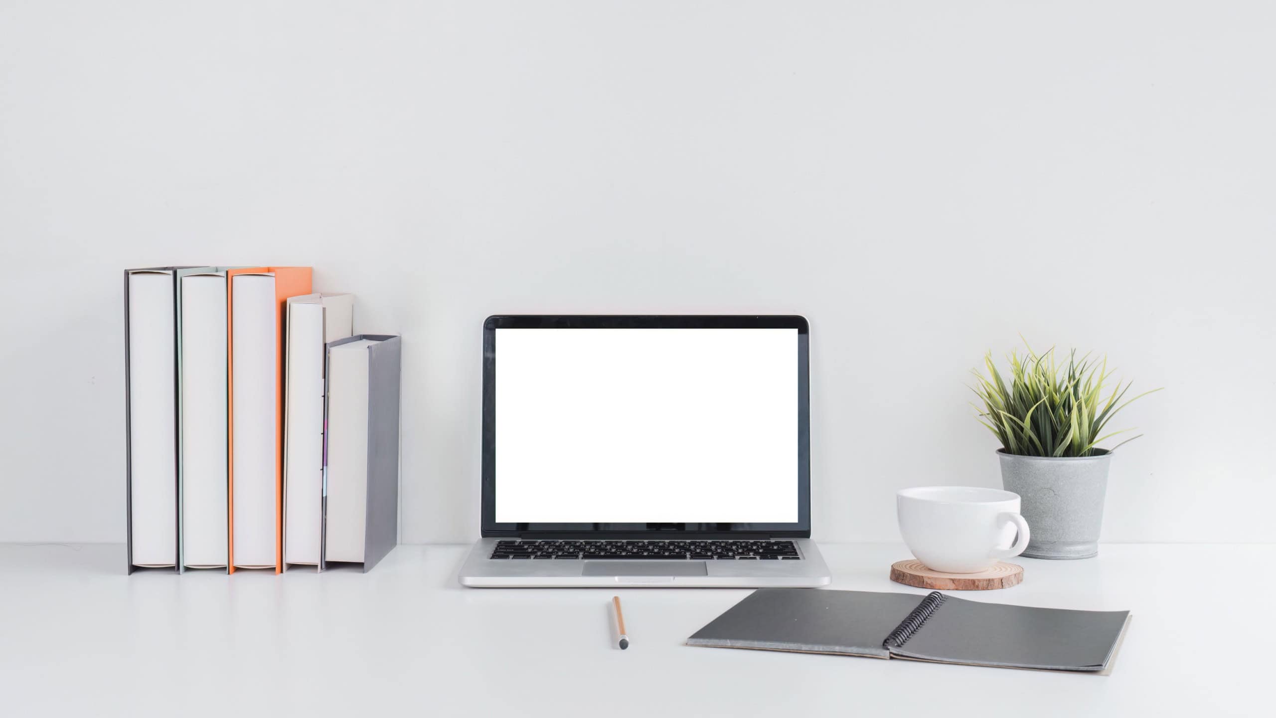 Minimalist Workspace with Laptop and Books on Desk