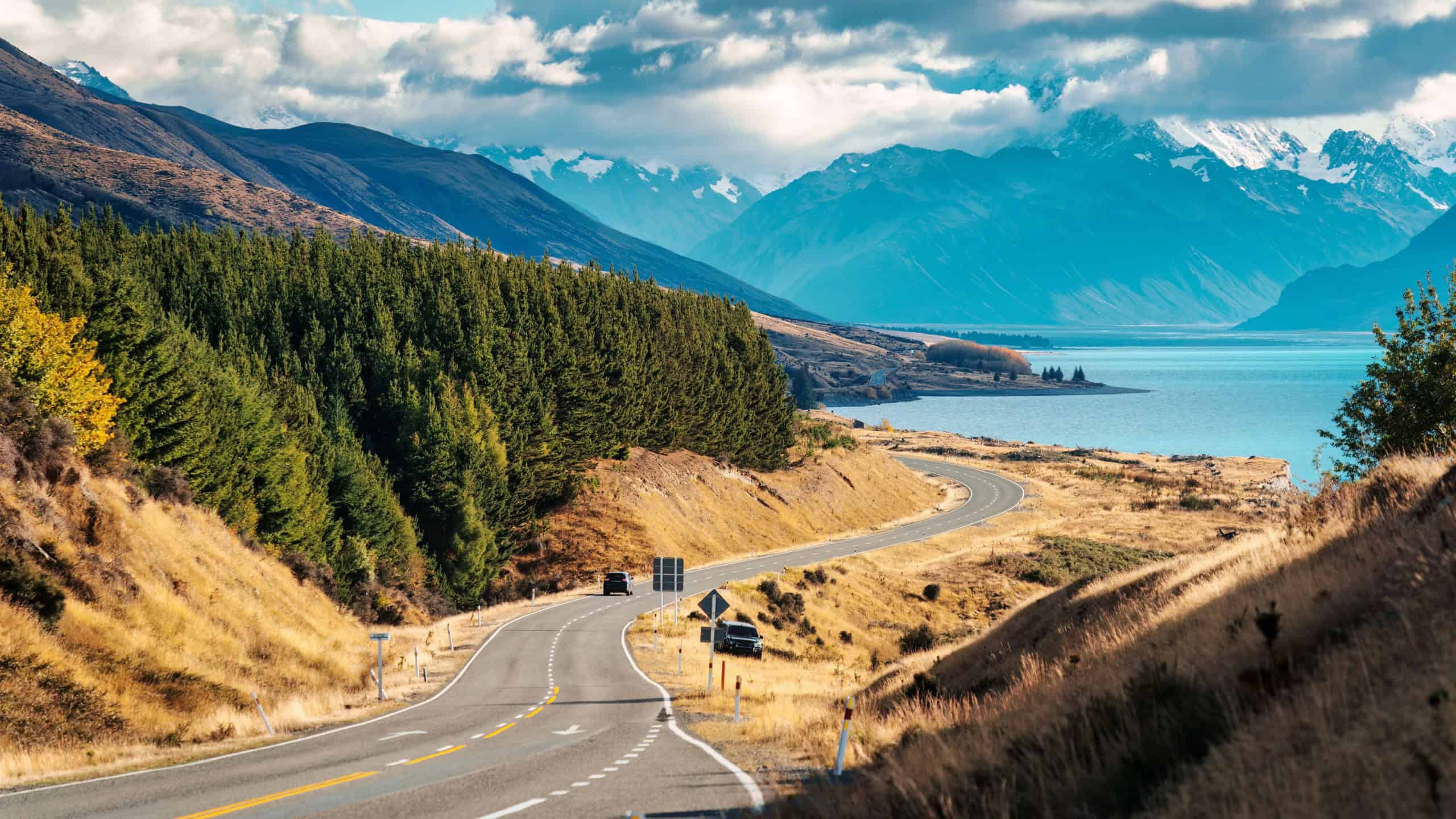 Scenic asphalt winding road with Mount Cook or Aoraki and Lake Pukaki on sunny day during autumn at Peters lookout, New Zealand