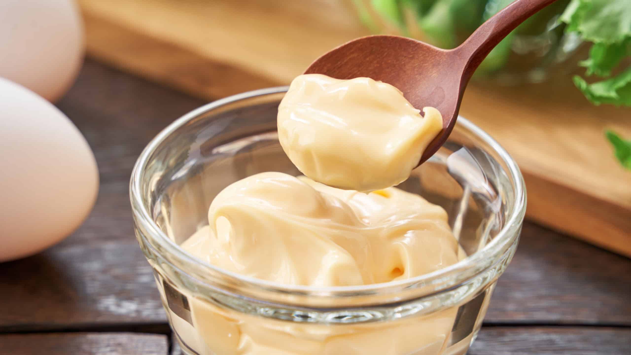 A Small Glass Bowl Filled with Mayonnaise on a Kitchen Counter