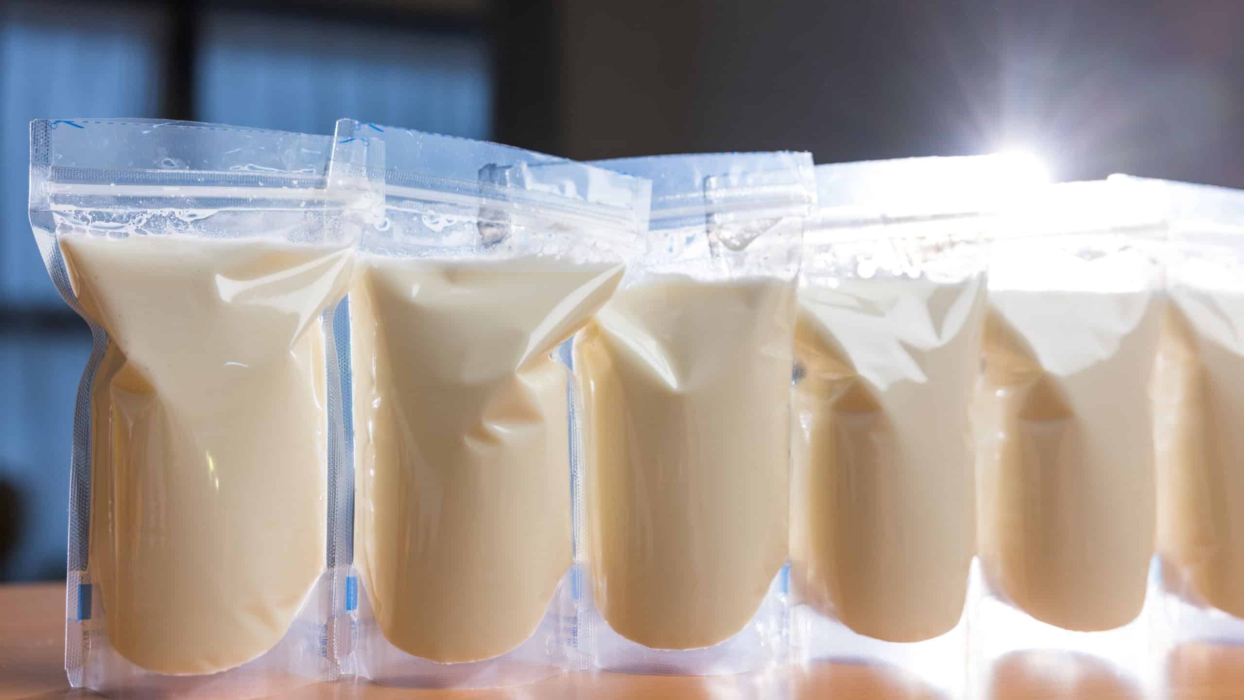 Frozen breast milk bags on wooden table