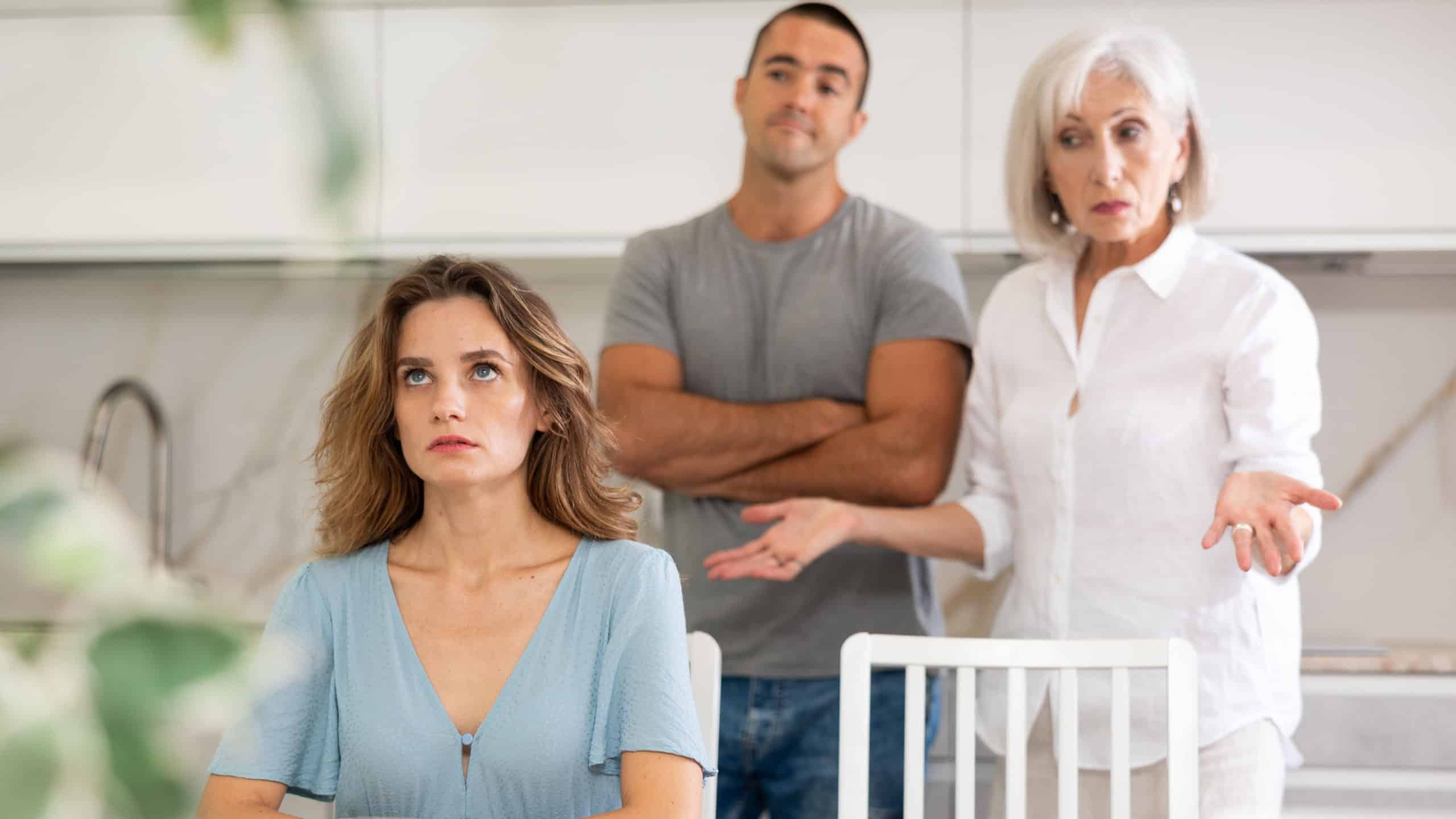 Family of three - mother-in-law, daughter and son quarreling in kitchen