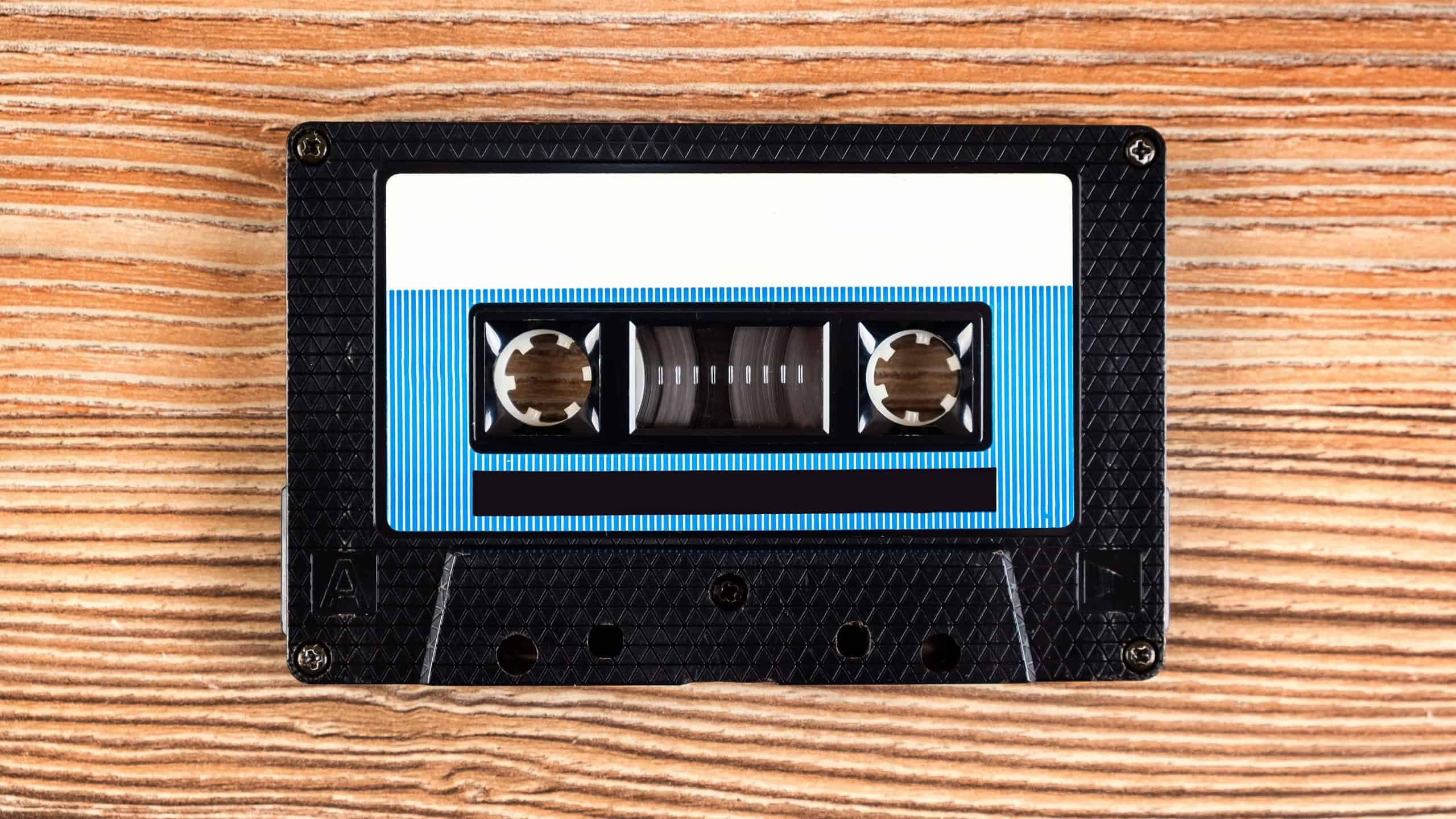 Old Audio Tape Cassette on Wooden Background closeup
