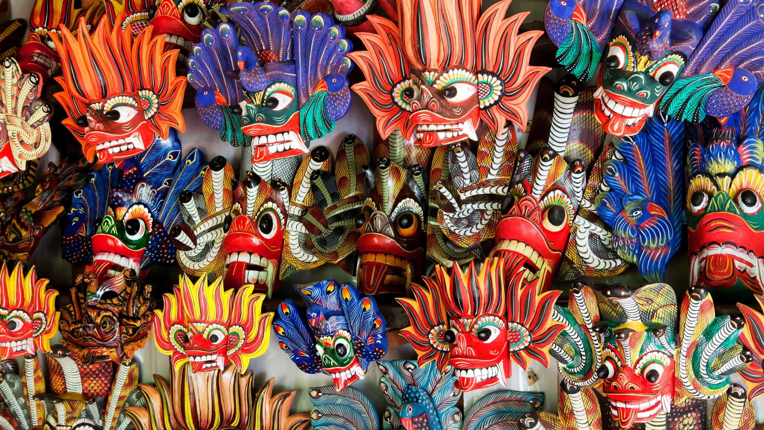 Colorful Raksha masks display intricate designs and vivid hues, symbolizing demon spirits in Sri Lankan festivals. These masks are essential in traditional dances.
