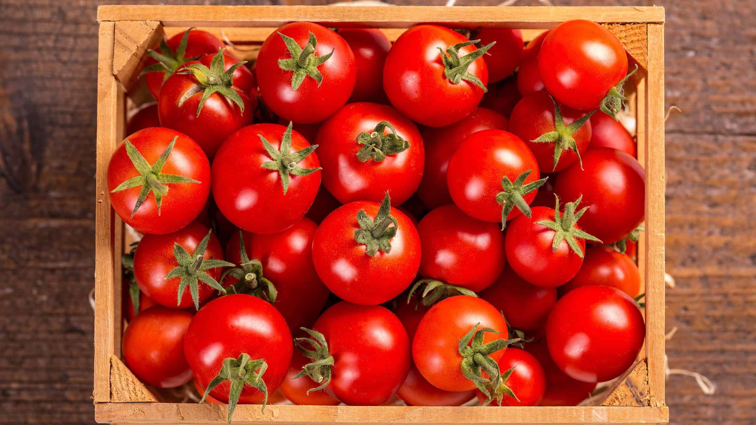 Top view of cherry tomatoes in small wooden crate
