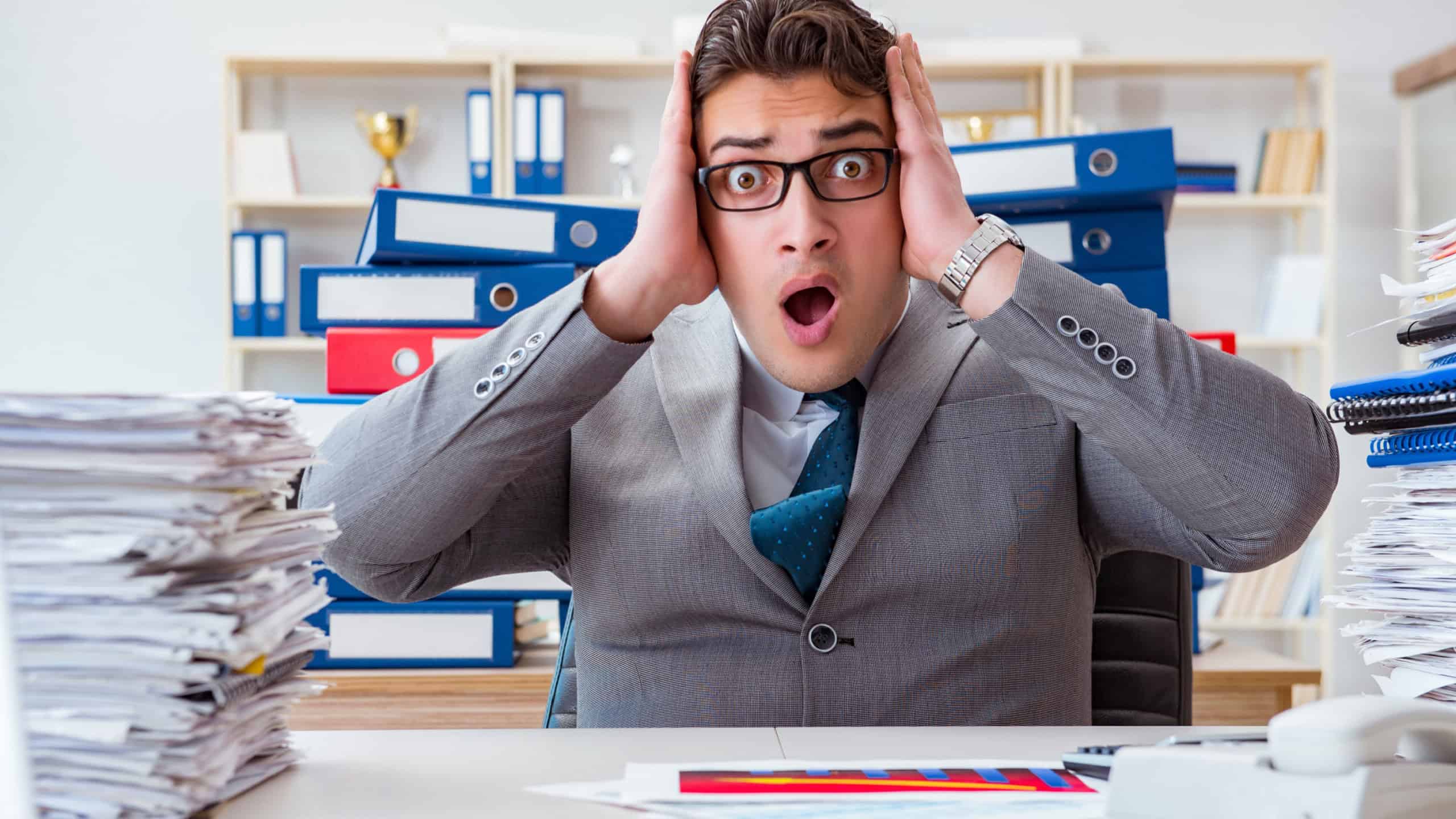 Businessman busy with much paperwork