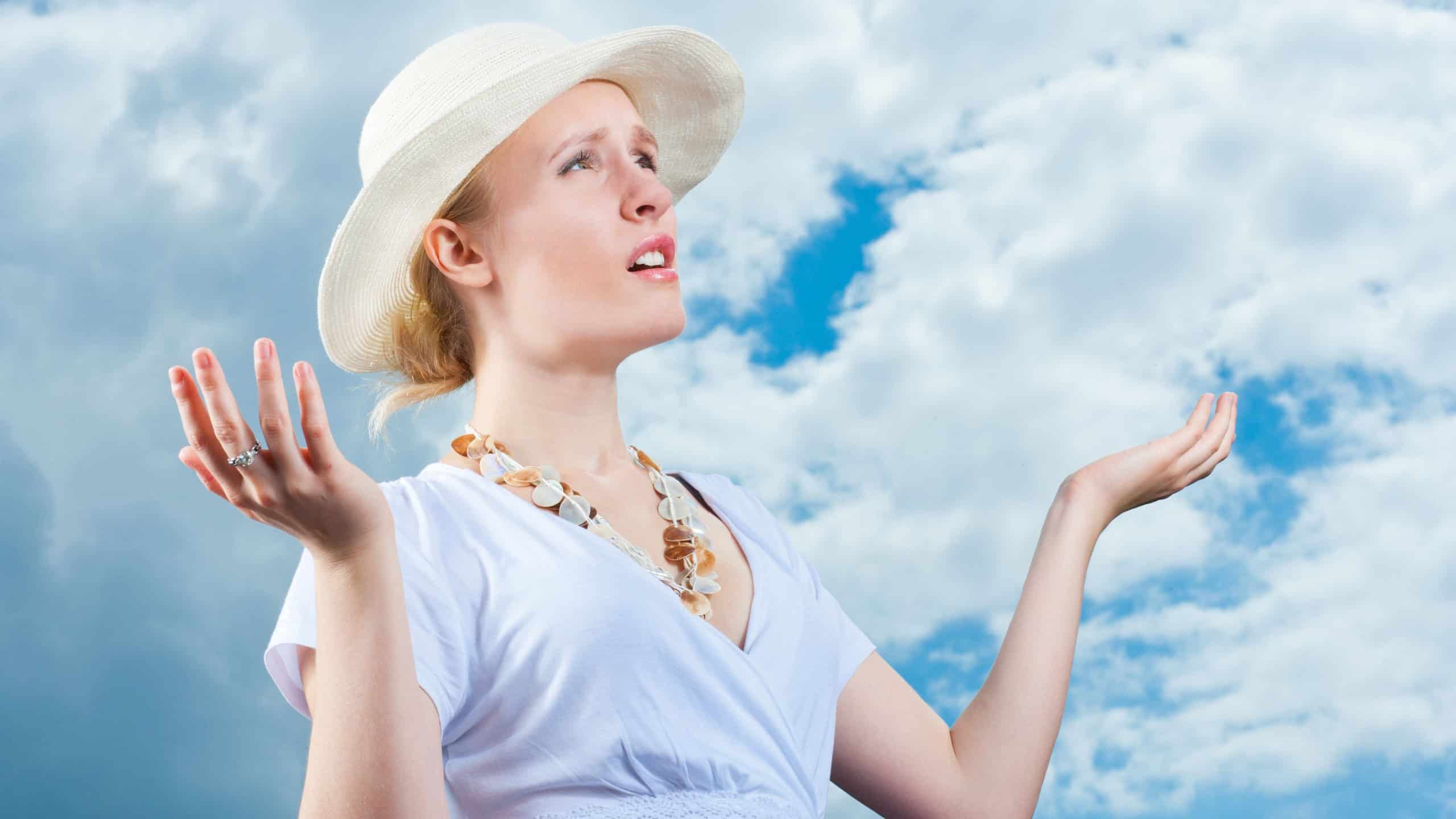 Young woman complains about weather change, dark clouds and rain are coming, bad weather concept
