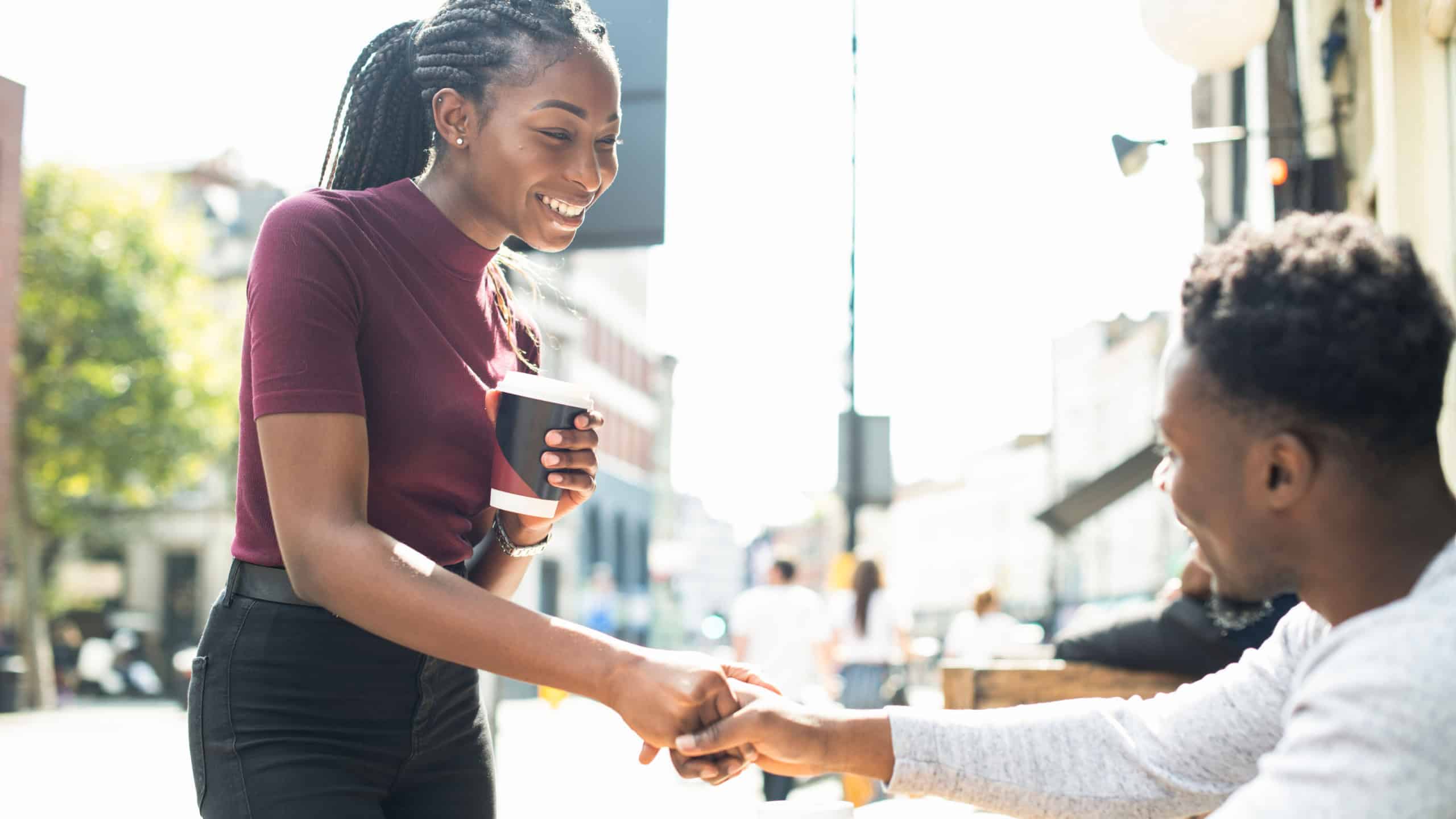 African couple shaking hands together