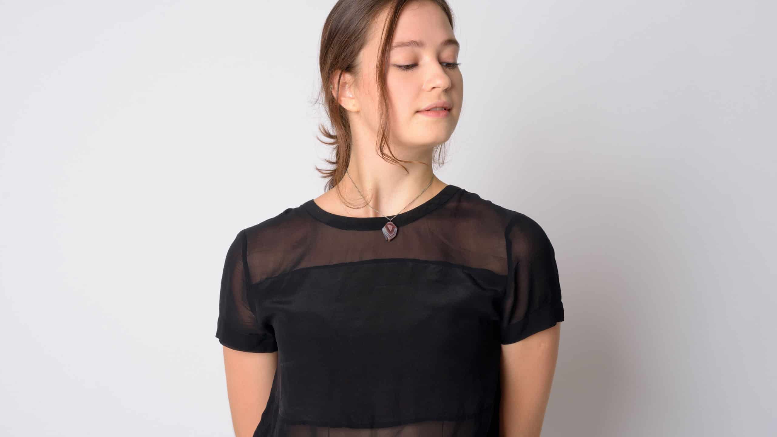 Face of young beautiful woman thinking and looking down