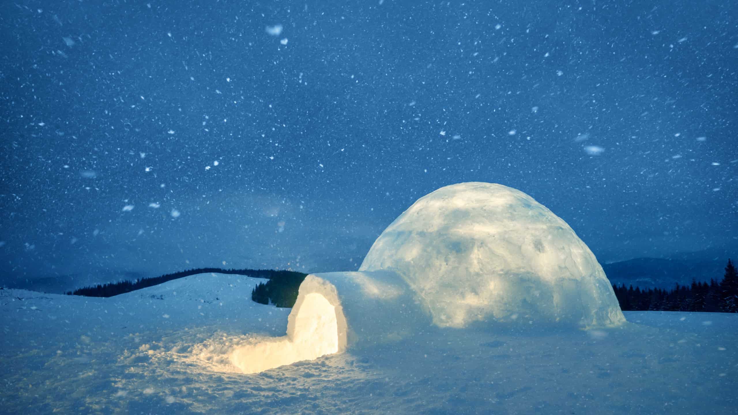 Wintry scene with snowy igloo and milky way in night sky. Fantastic winter landscape glowing by star light. Santa house from snow, ideal New Year and Christmas background