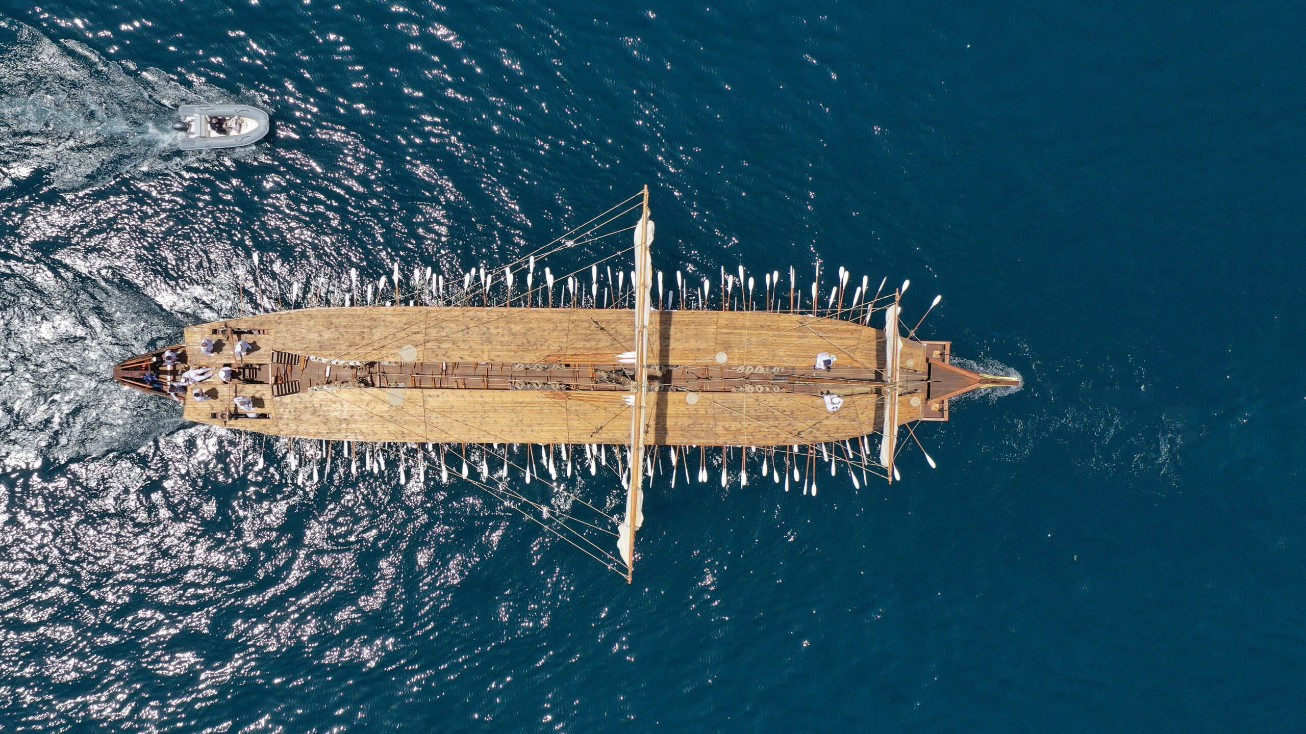 Aerial drone ultra wide photo of beautiful replica of ancient Athenian Trireme cruising in deep blue sea near port of Faliron Athens Riviera, Attica, Greece