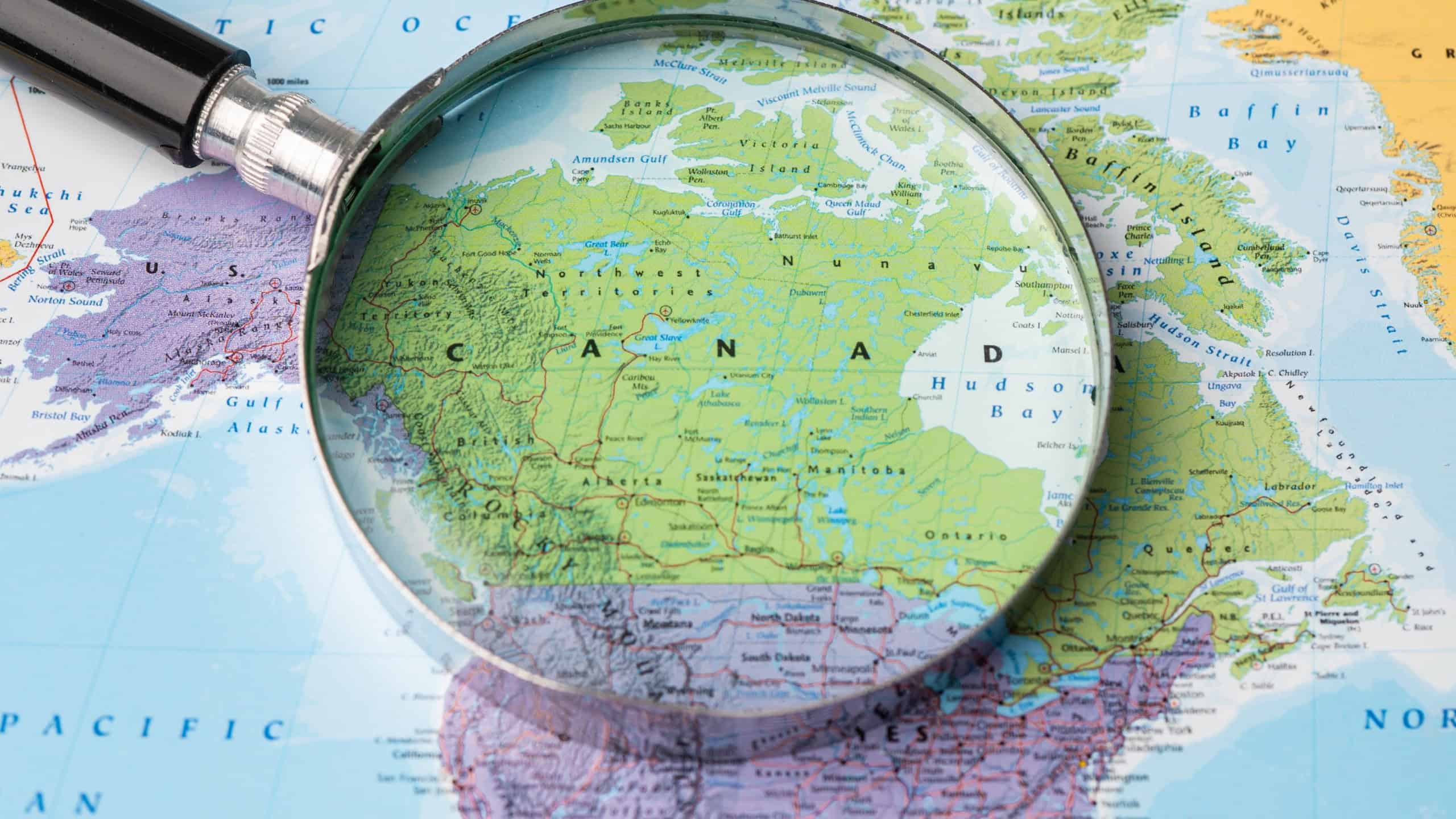 November 01, 2020 Canada, Magnifying glass close up with colorful world map