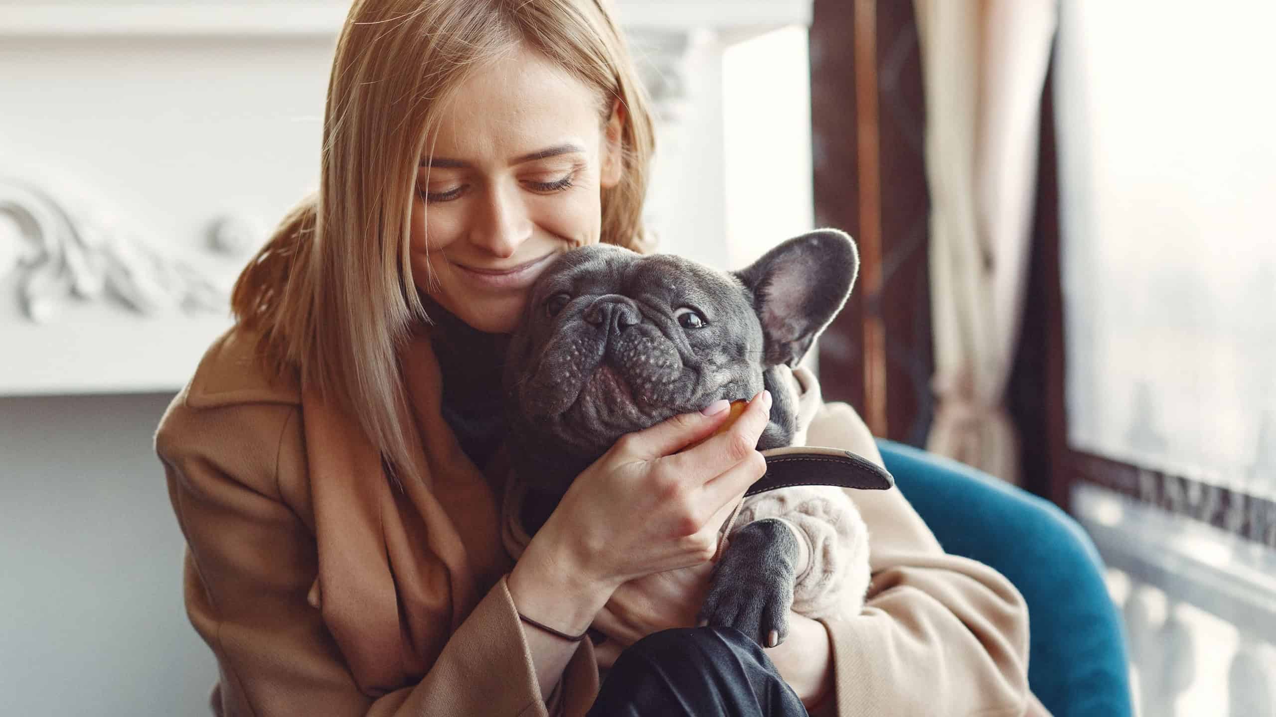 Elegant woman in a brown coat with black bulldog