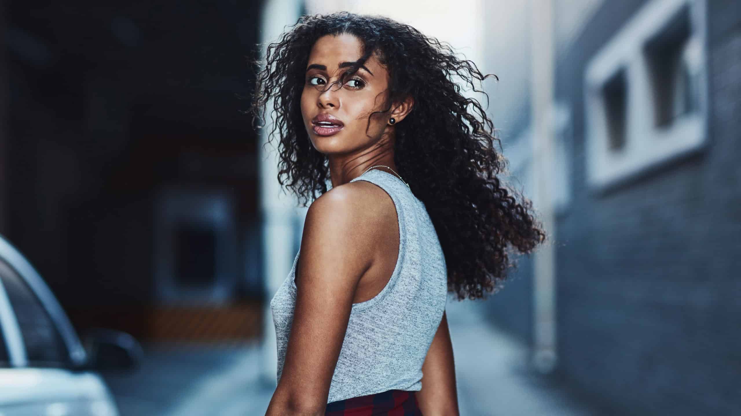 She doesnt enjoy being catcalled in the city. Shot of an attractive young woman being catcalled in the city.