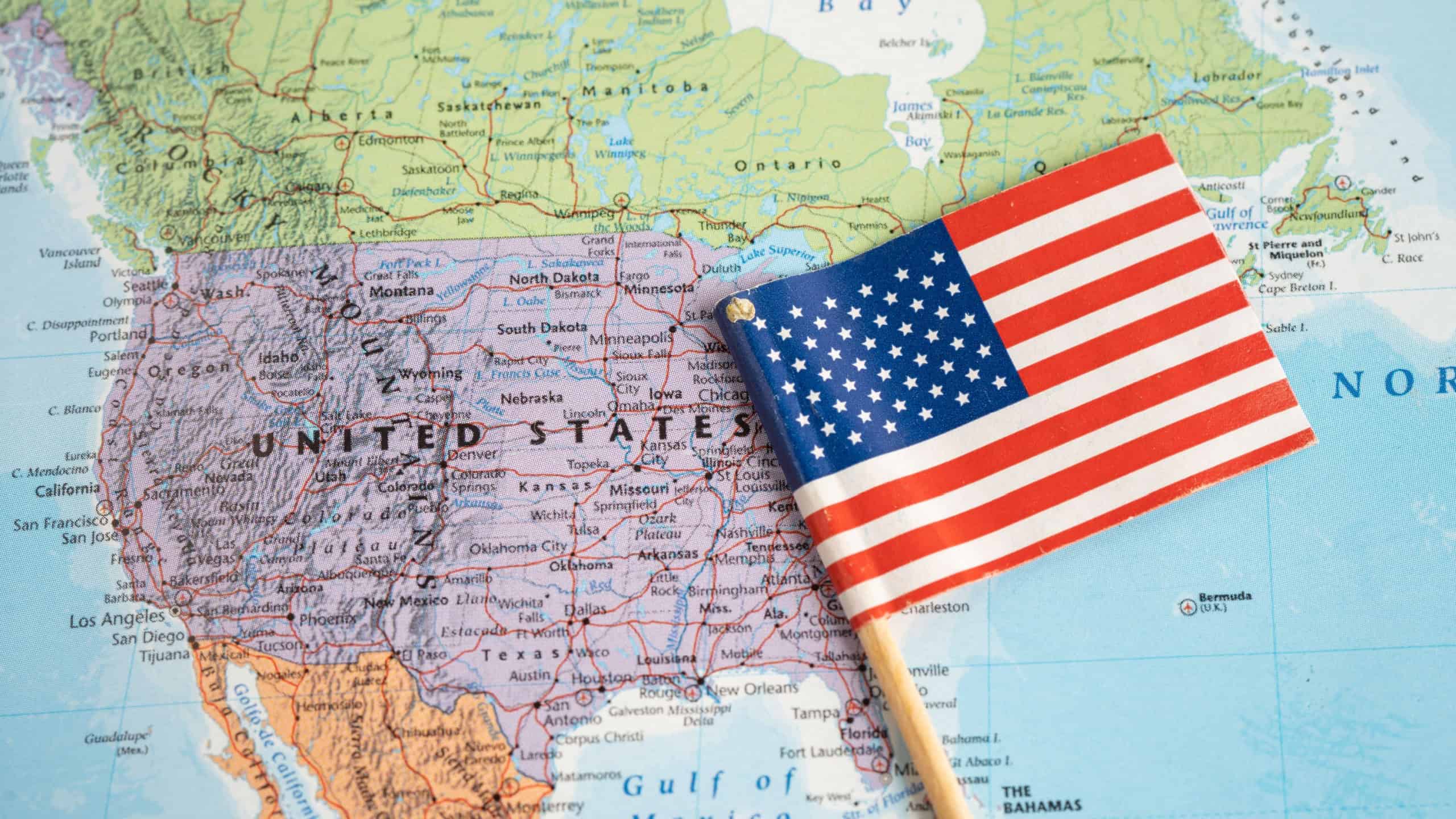 February 1, 2022 USA America flag on world map background.