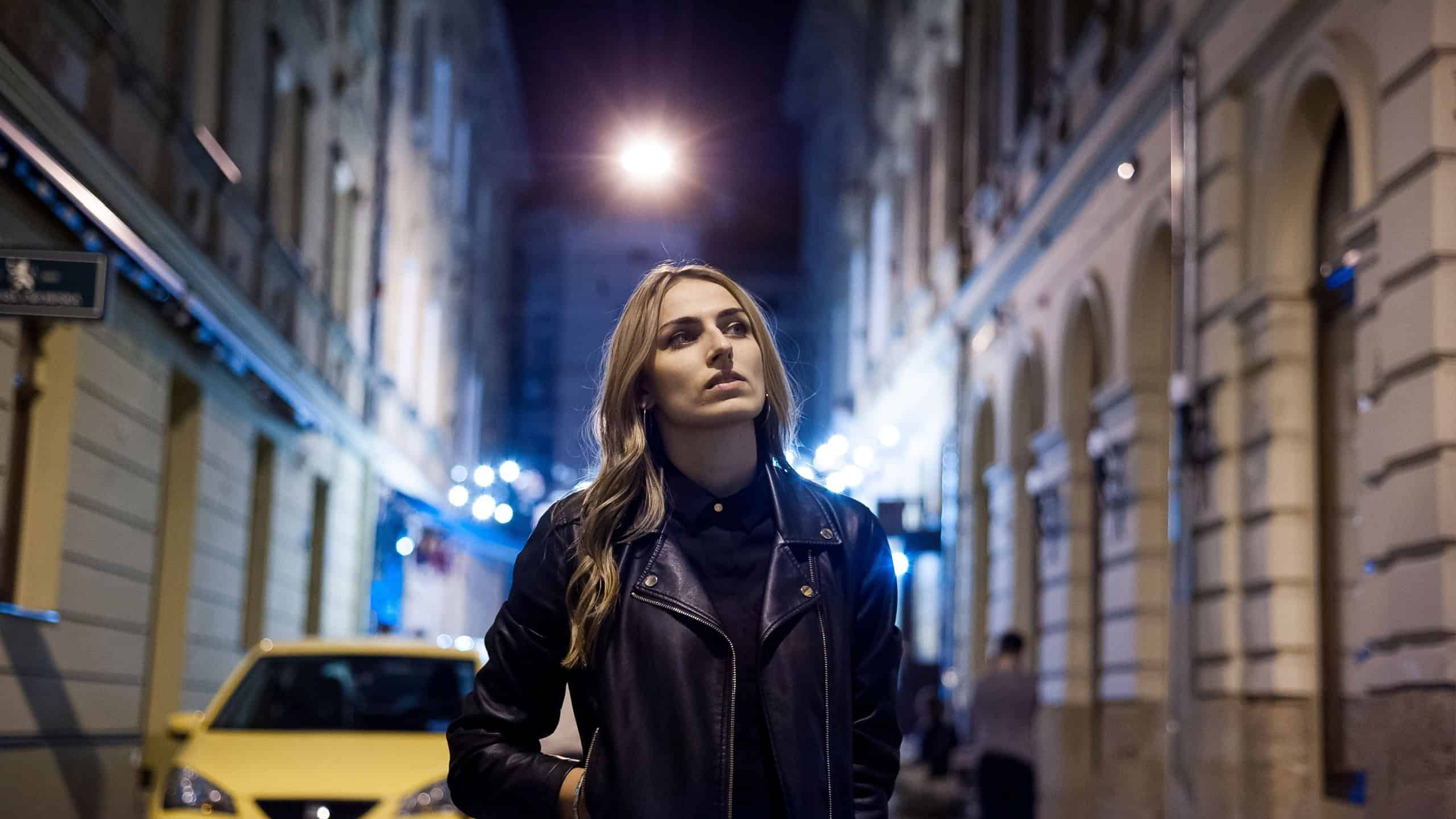 Beautiful woman is walking in the night city.