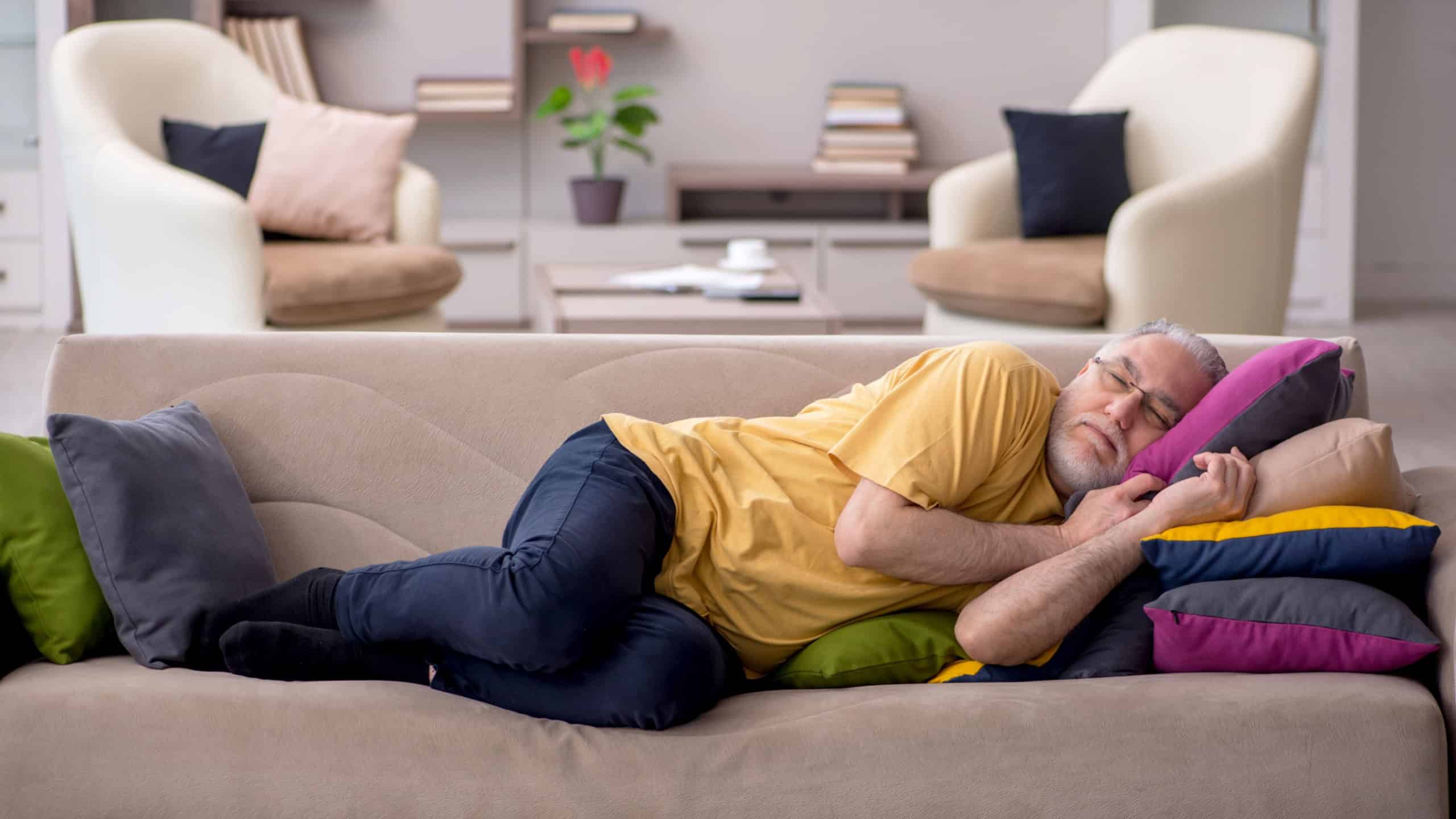 Old man with many pillows at home