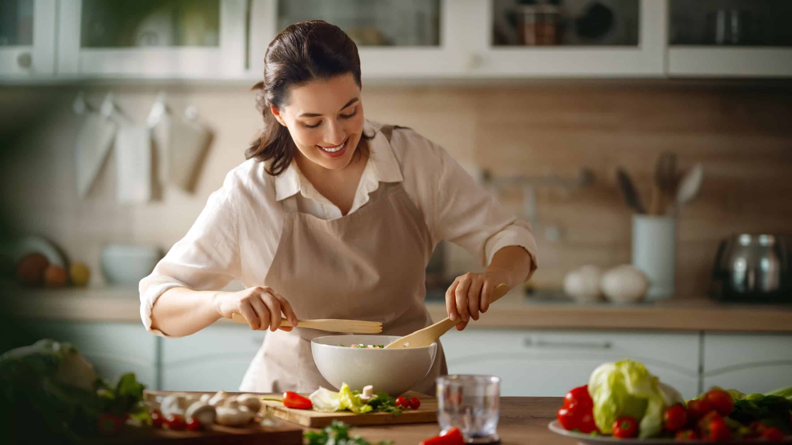 Healthy food at home. Woman is preparing the proper meal in the kitchen.