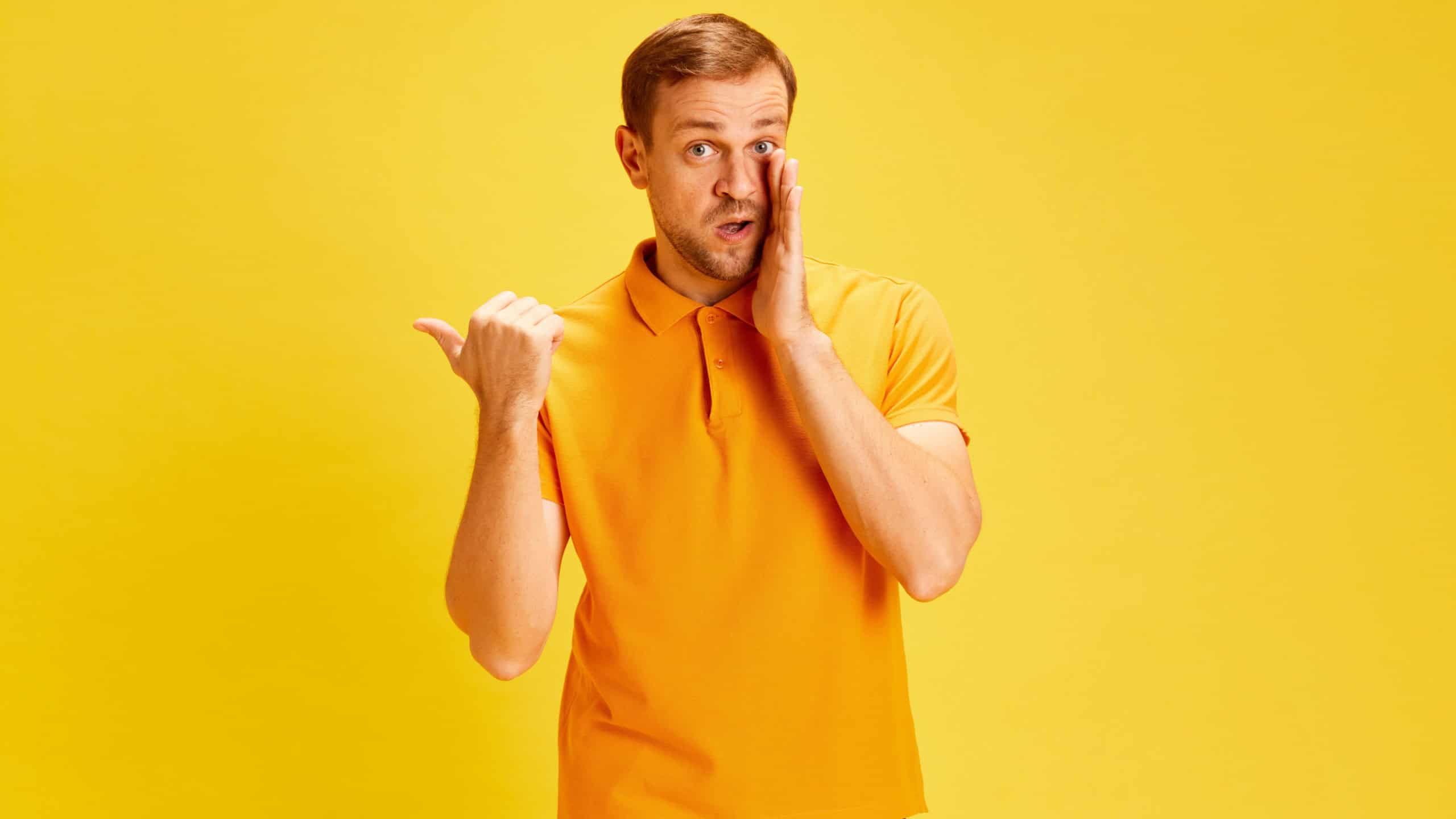 Portrait of young handsome man wearing style casual outfit looking at camera nd translate fun whisper gossip and tell secret. Concept of facial expression, human emotions. Copy space for ad, text