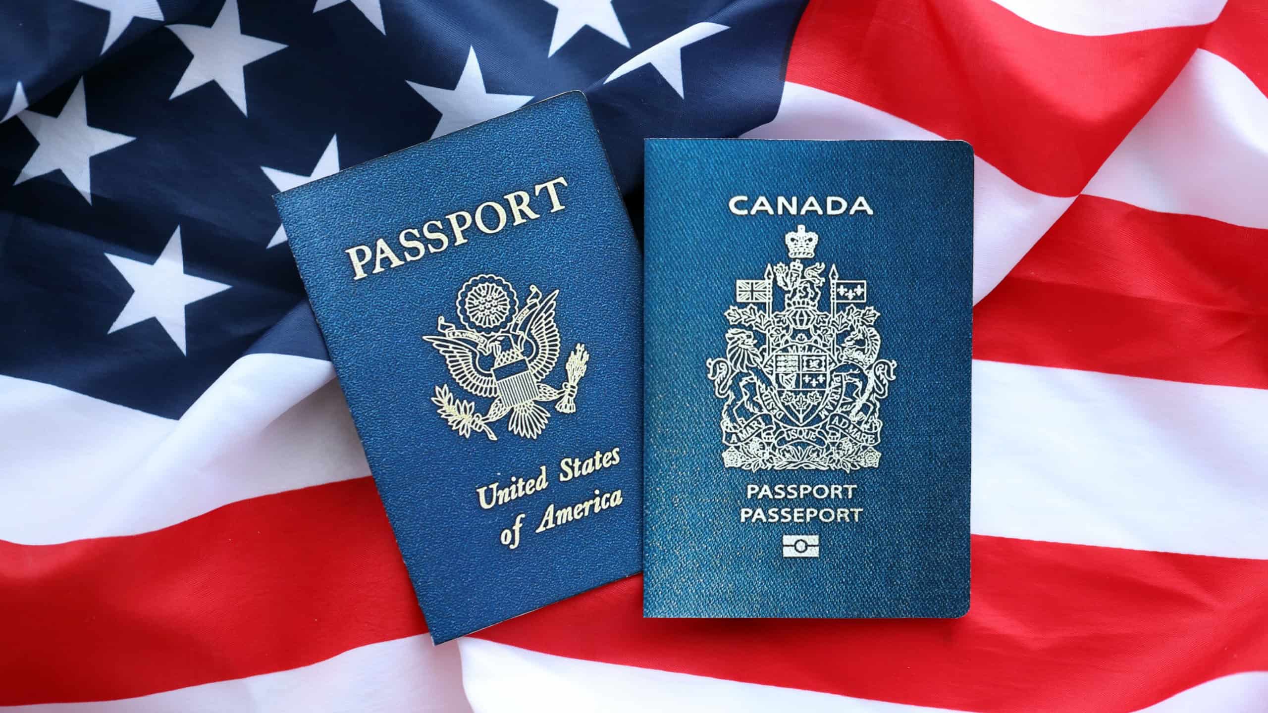Passport of Canada with US Passport on United States of America folded flag close up
