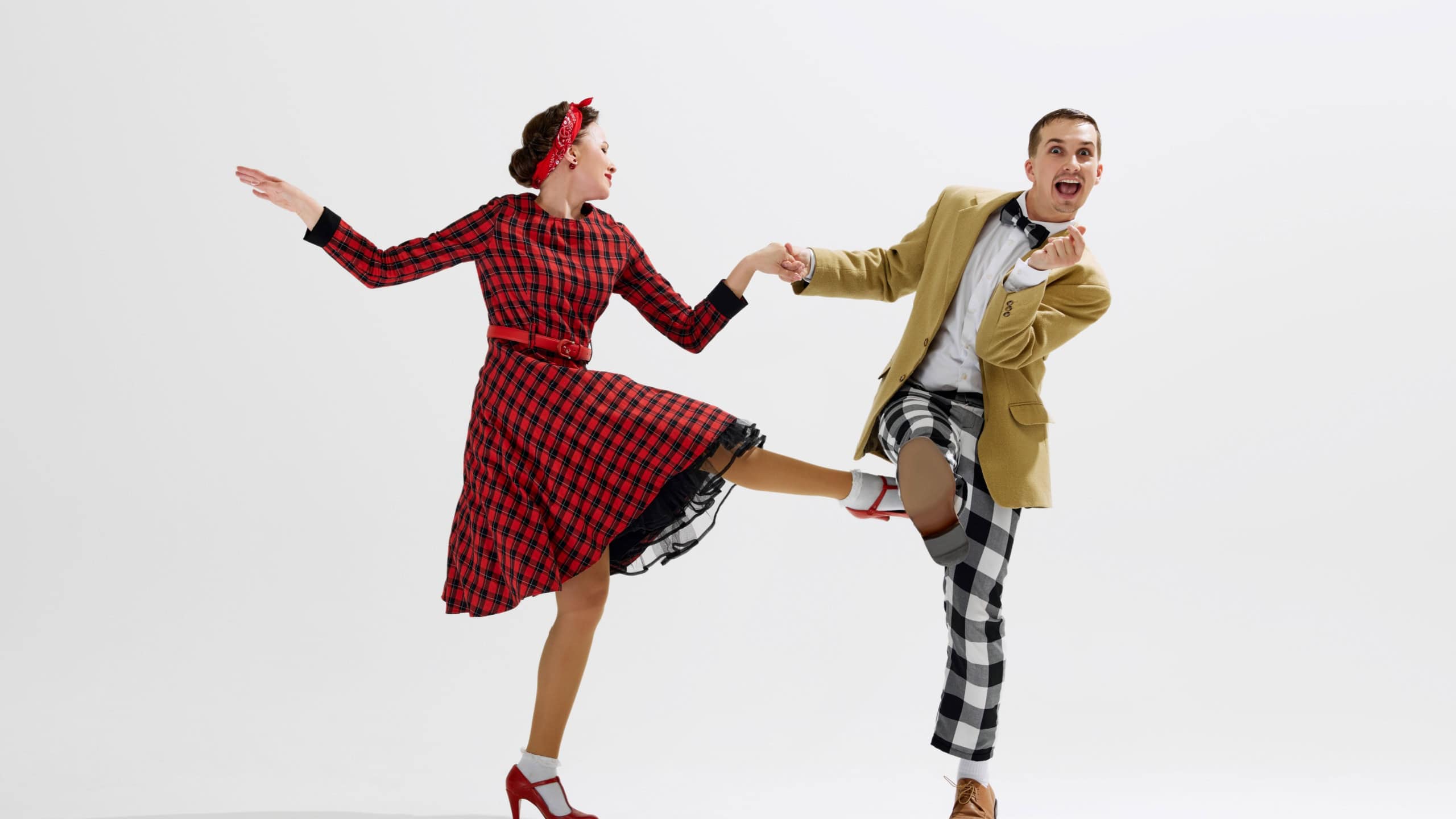 Boogie woogie. Stylish young man and elegant woman emotionally dancing isolated over white studio background. Concept of art, retro and vintage, hobby, entertainment, 20s