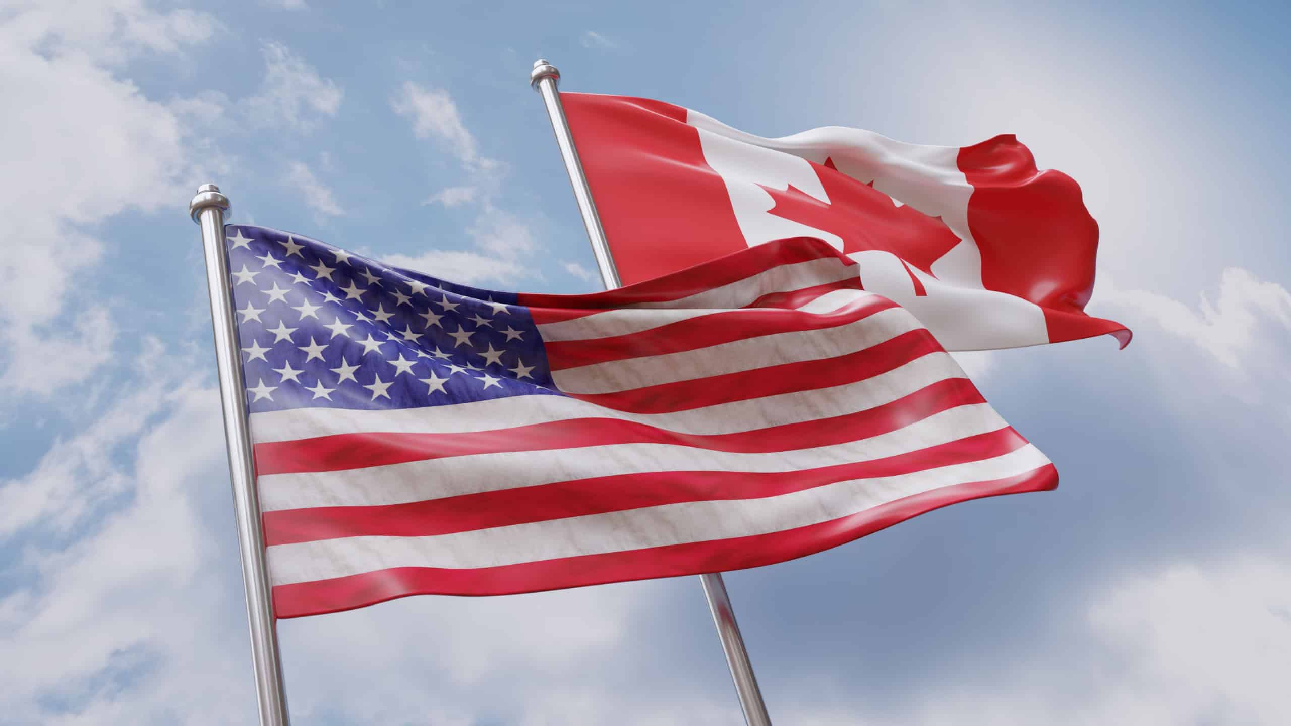 USA and Canada. United States of America and Canadian country flags waving on blue sky, 3d render