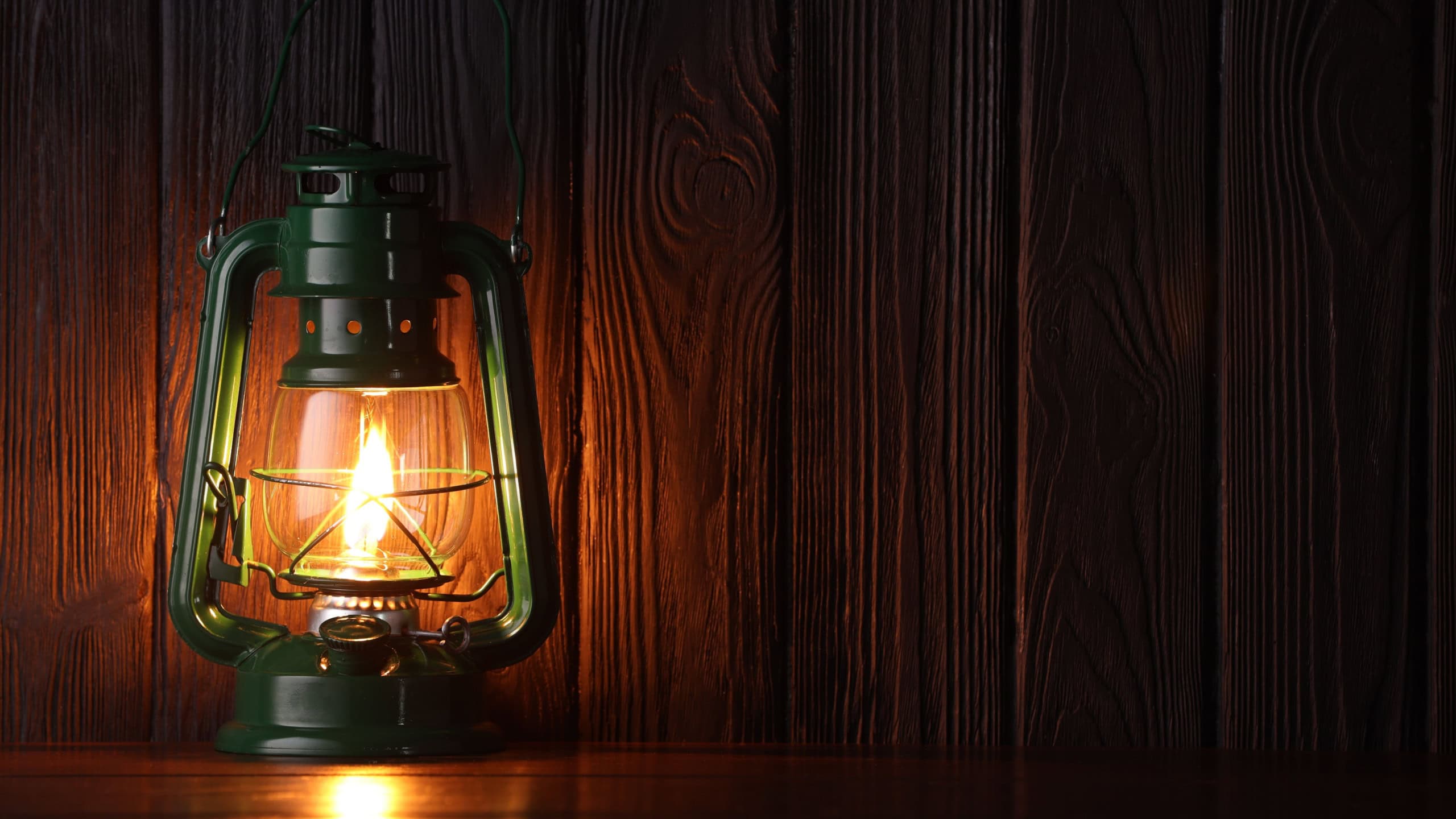 Vintage kerosene lamp on wooden table. Space for text