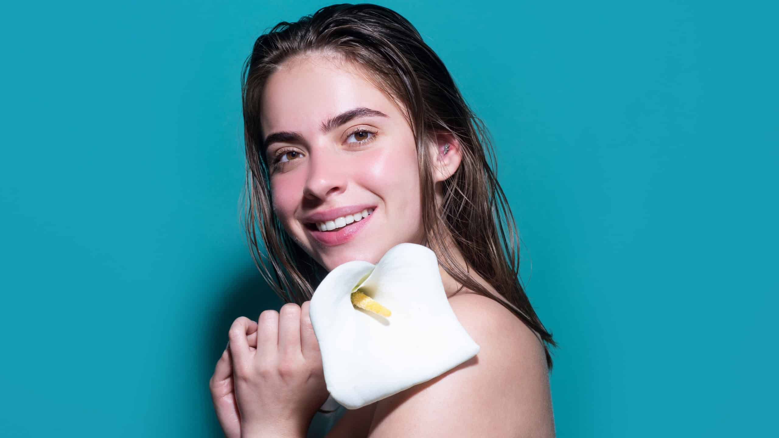 Tenderness and beauty. Happy smilig woman with flowers. Beauty girl with calla lily. Beautiful sensual woman hold flowers, studio portrait.