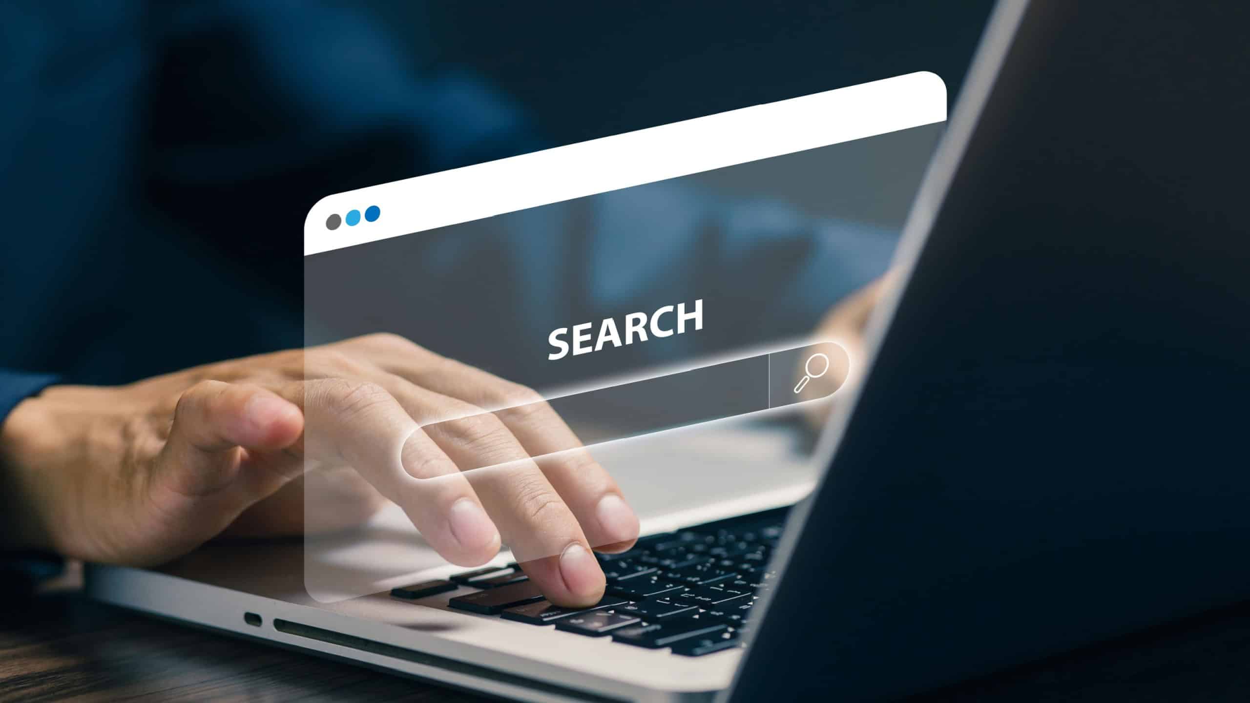 Online search concept with virtual search bar on laptop screen, representing internet browsing, information discovery, SEO optimization, digital marketing and modern web navigation technology.