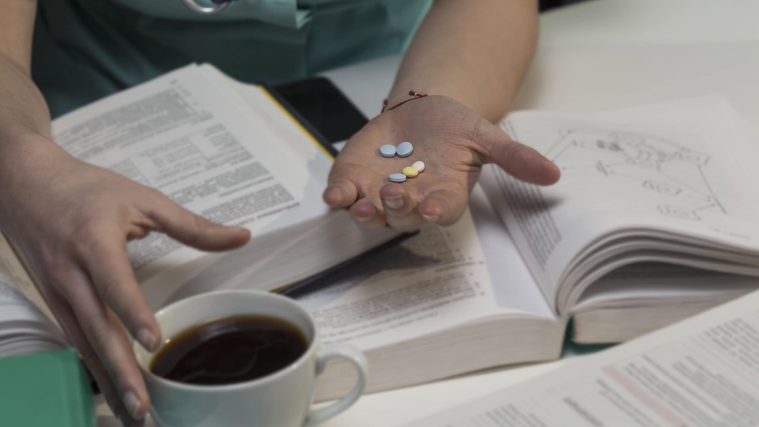 Student of medicine takes pills for better concentration