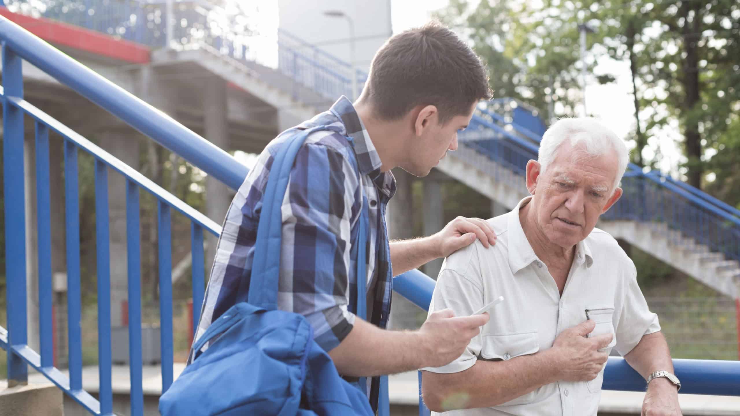 Helpful young man talking with male retiree