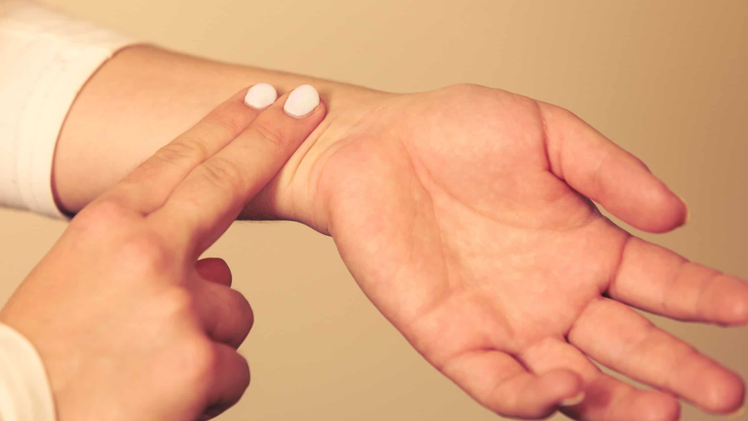 Medicine health care. Female hand checking pulse on wrist closeup. 