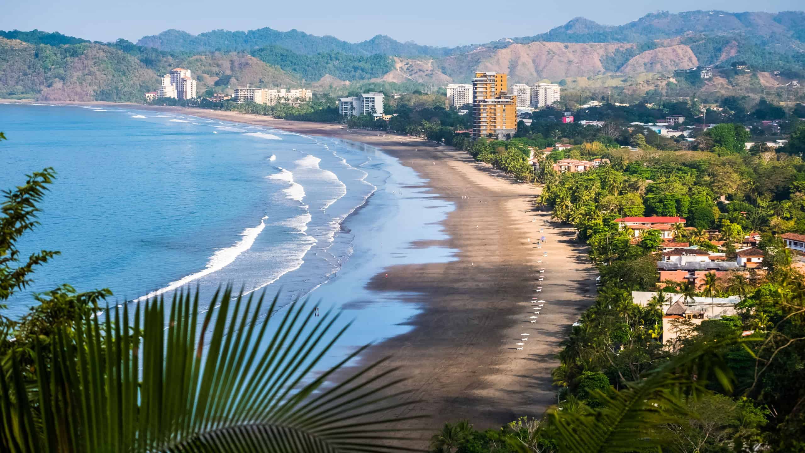 Tropical wide sandy beach of the town of Jaco, Costa Rica