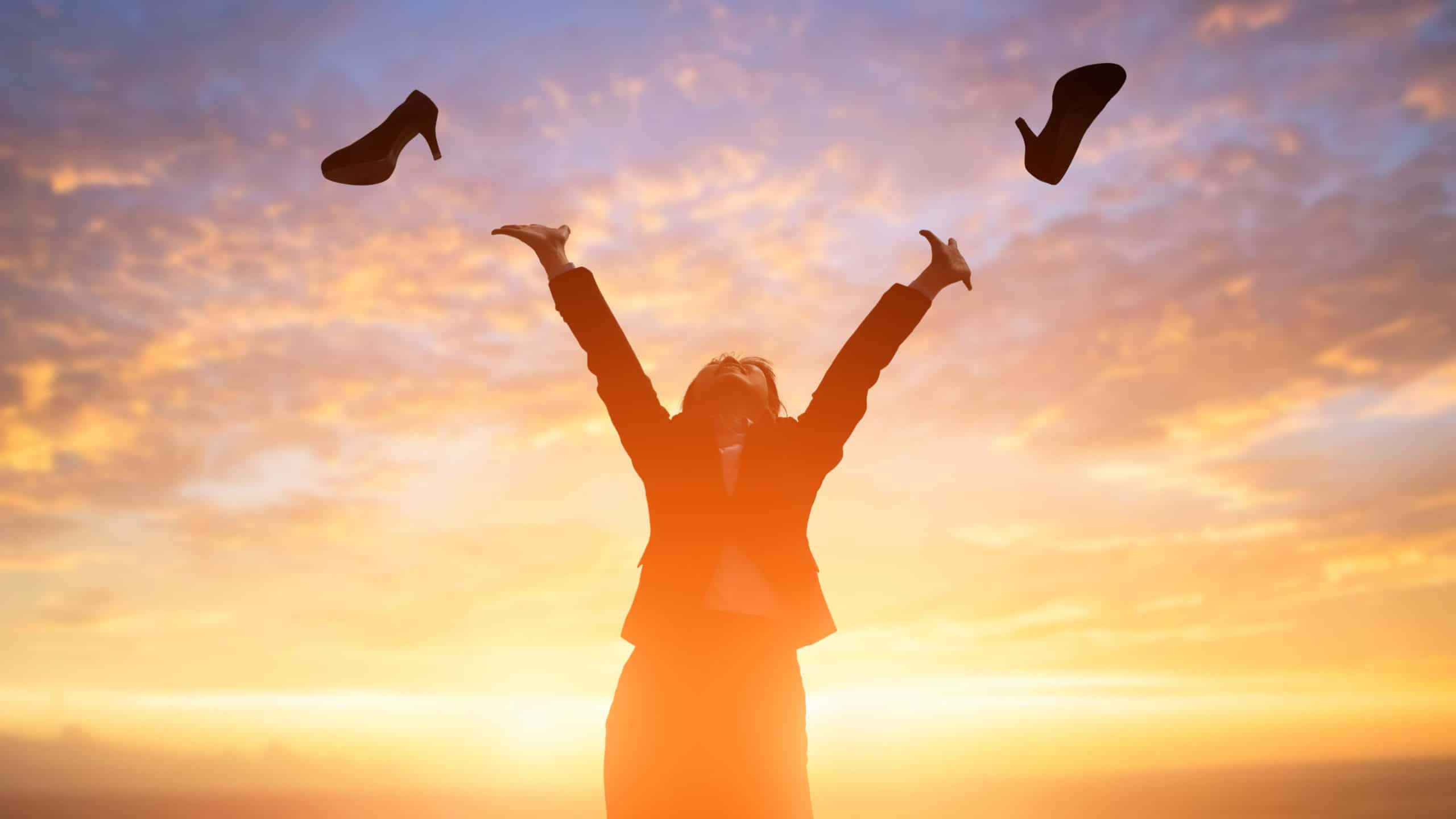 silhouette of business woman throw high heels in the air