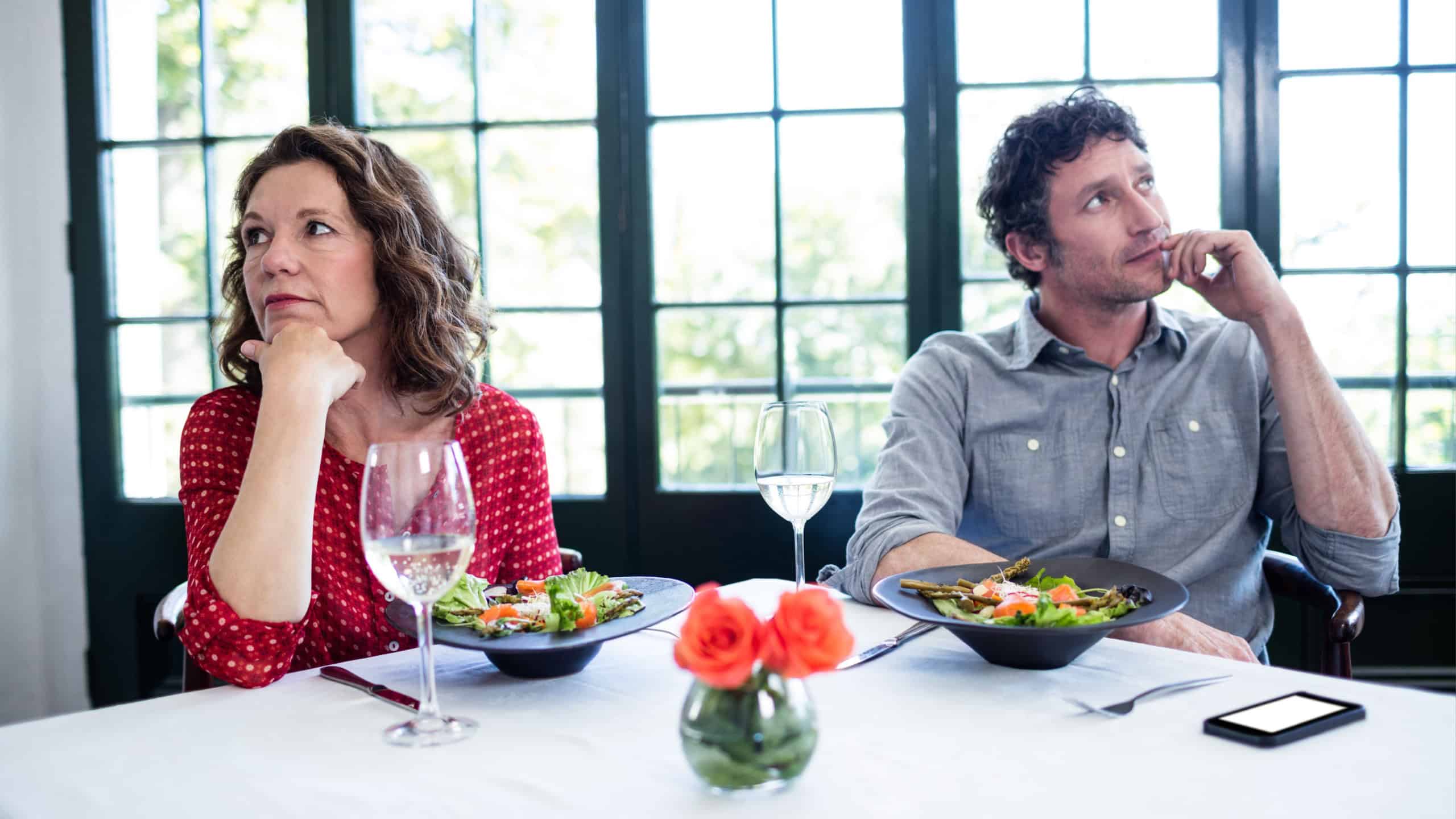 Woman feeling bored and ignoring each other in restaurant