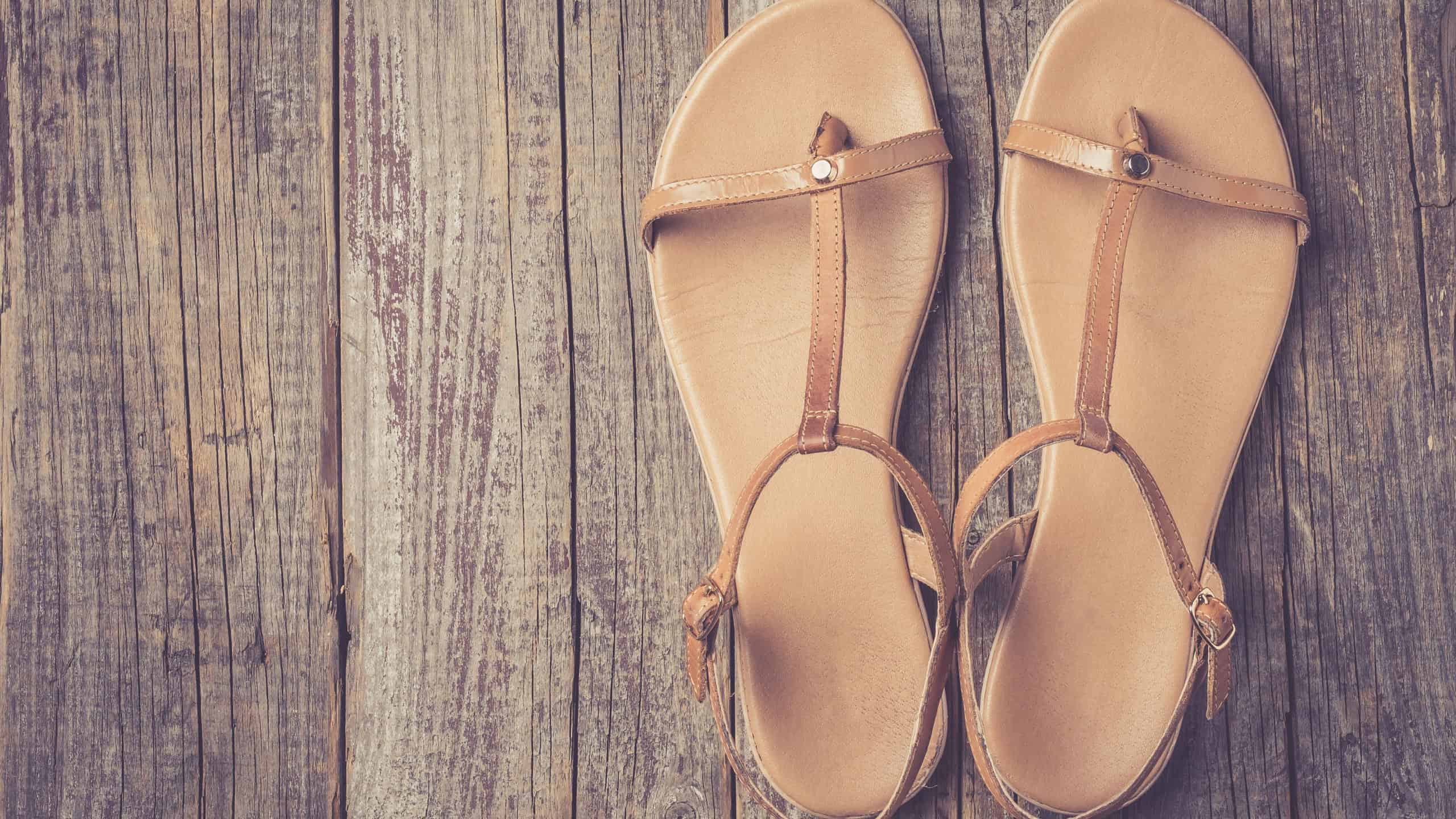 Female shoes on an old wooden table (sandals)