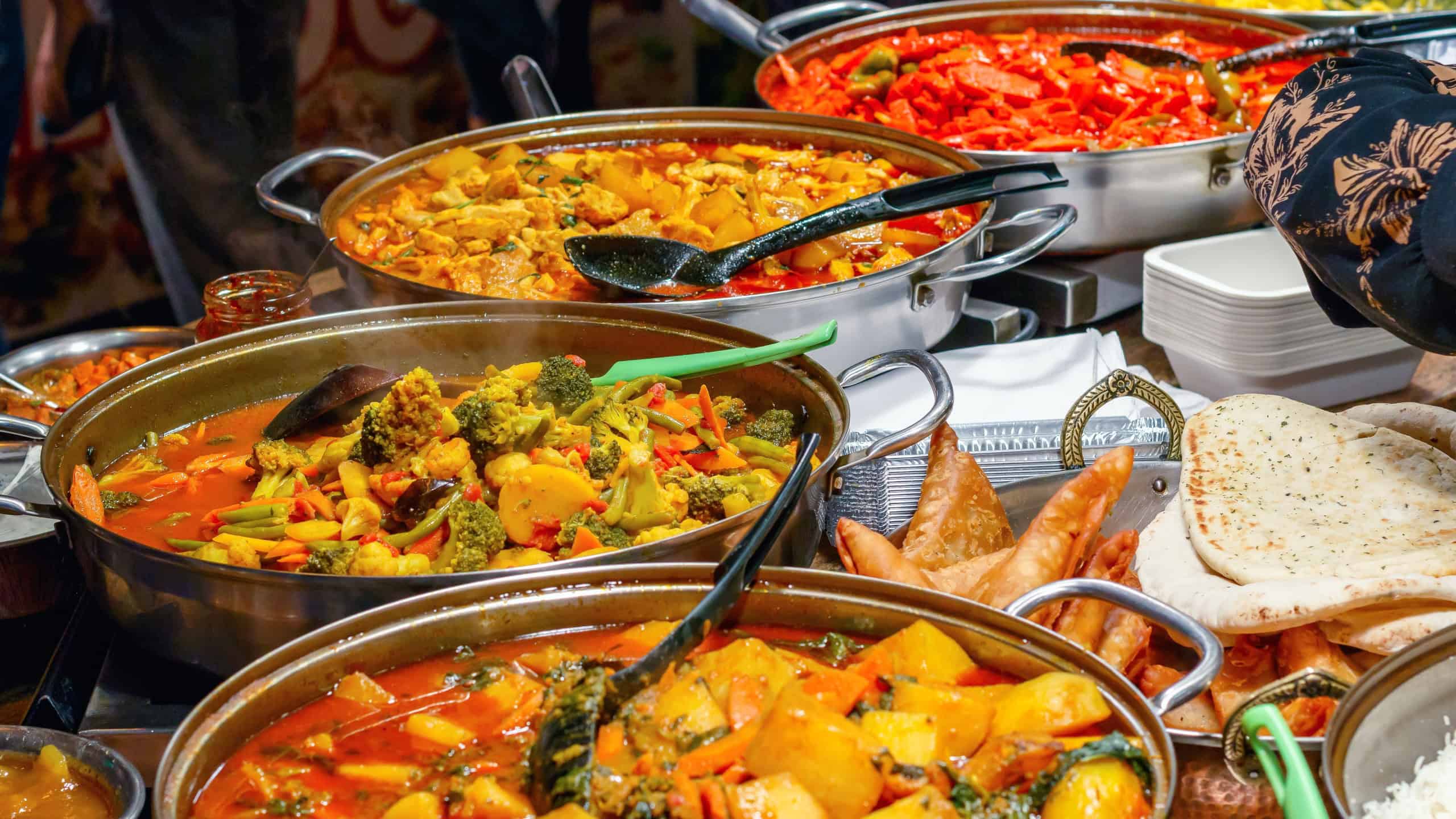 Variety of cooked curries on display at Camden Market in London